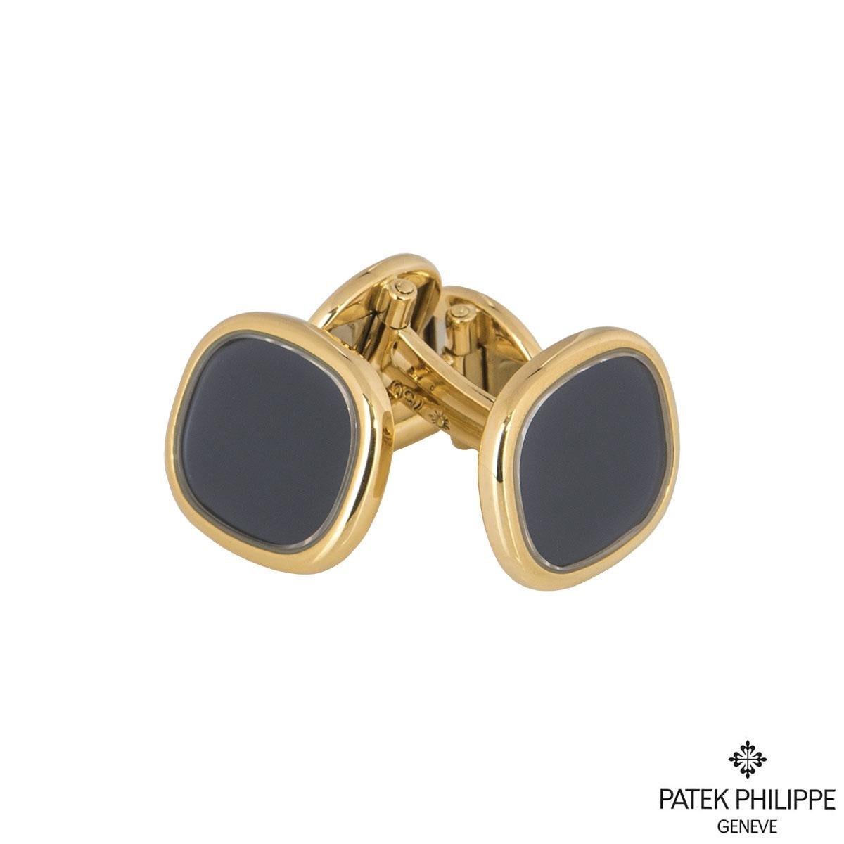 A pair of 18k yellow gold by Patek Philippe from the Ellipse collection. The cufflinks are set to the front with a blue accent dial with a polished yellow gold surround, measuring 1.40cm in height and 1.60cm in width. The cufflinks have T-bar