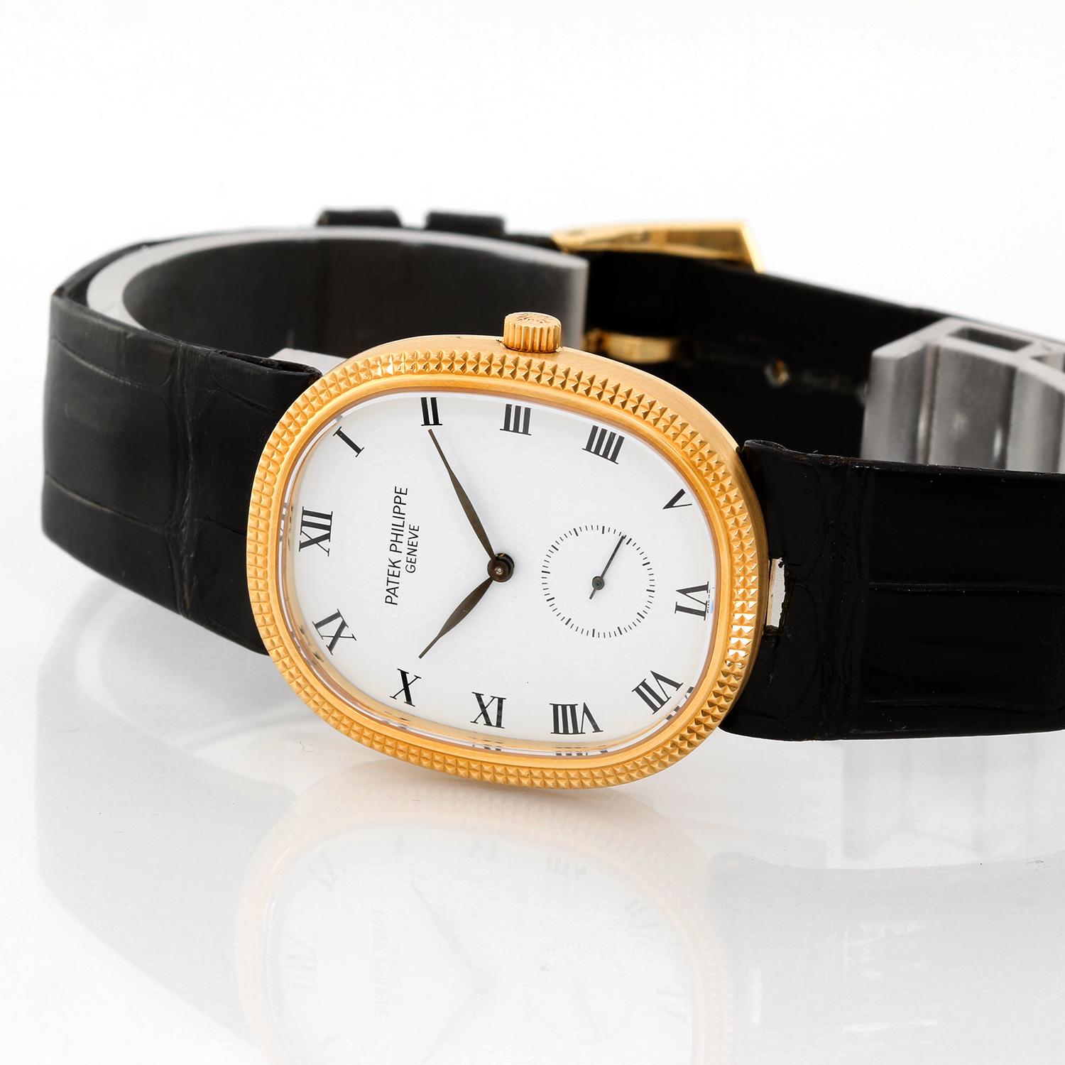 Patek Philippe 18k Yellow Gold  Ellipse Men's Watch Ref. 3978 - Manual . 18k yellow gold case (27mm x 32mm). White dial with black Roman numerals; seconds subdial. Patek Philippe & Co. leather band with 18k yellow gold Patek Philippe buckle.