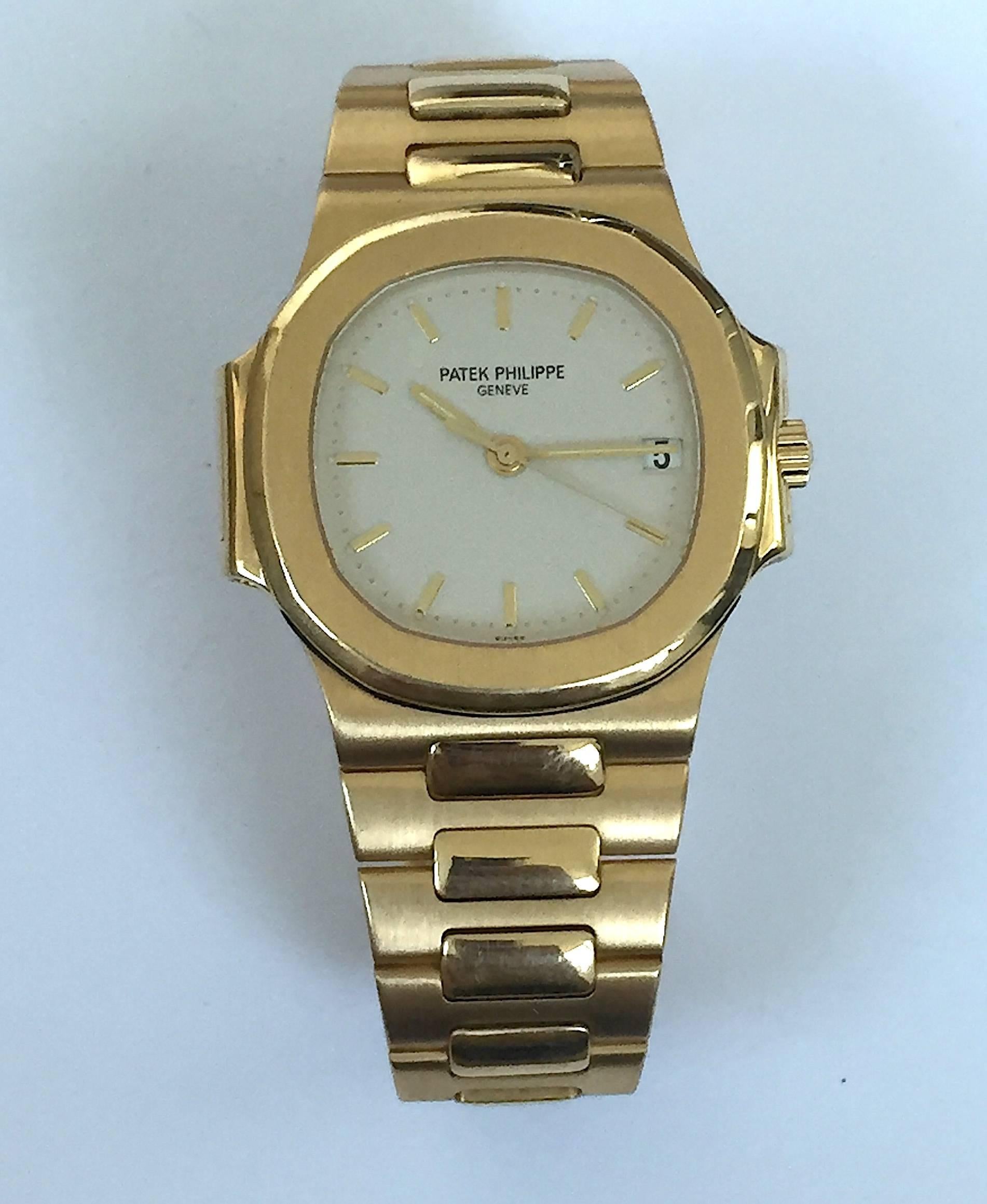 Patek Philippe 18K Yellow Gold Nautilus Watch
Factory Original Silver/Ivory Color Dial with Inlaid Beading Around the Perimeter and Swiss Marking
18K Yellow Case
Reference 3800
38mm Size
Patek Philippe Automatic Wind Movement 
Sapphire Crystal
Circa
