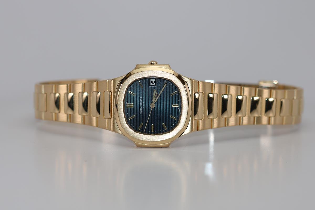 Pre-owned Patek Philippe Nautilus Ref 3900/1 in 18k yellow gold powered by Patek Philippe's caliber E 23 SC, 7-Jewel quartz movement.