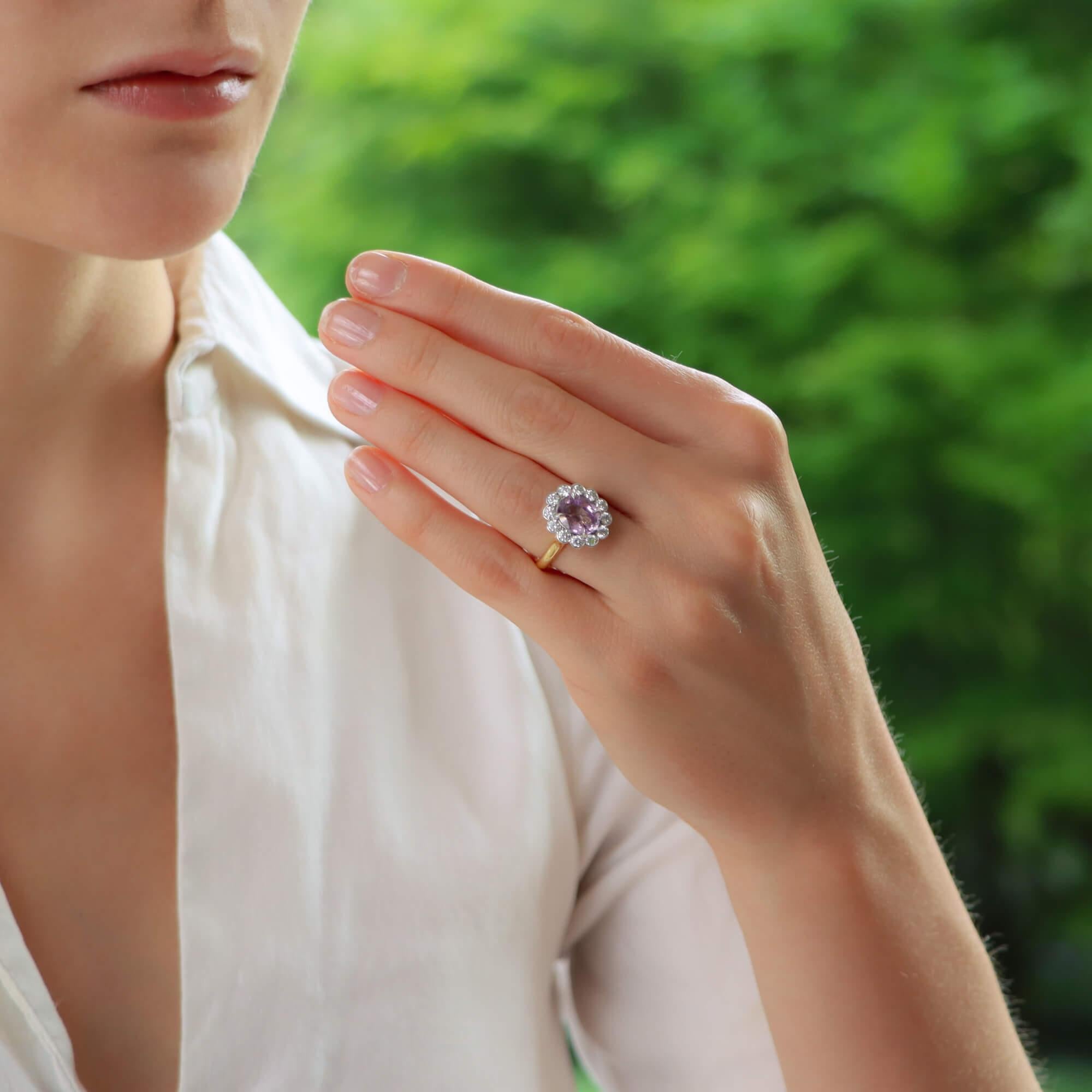  A truly stunning pastel pink sapphire and diamond cluster ring set in 18k yellow and platinum.

The piece is centrally set with a beautiful 2.59 carat oval cut pink sapphire which is claw set in platinum. The sapphire has a fantastic vibrant pastel