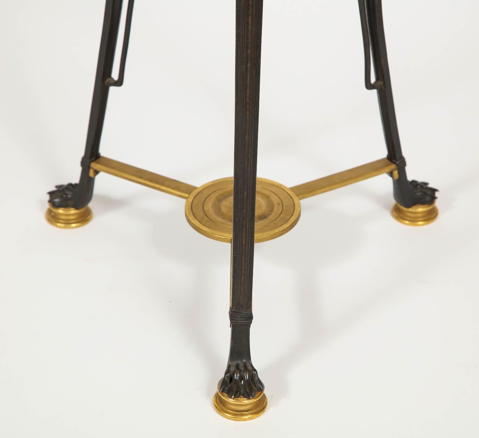 A Beautifully Designed Small Patinated and Dore Bronze French Side Table, Attributed to F. Barbedienne, the Magnificent French Metalworker and Manufacturer.  This beautifully cast and hand-chased Empire/ Neo-Grec side table has been beautifully