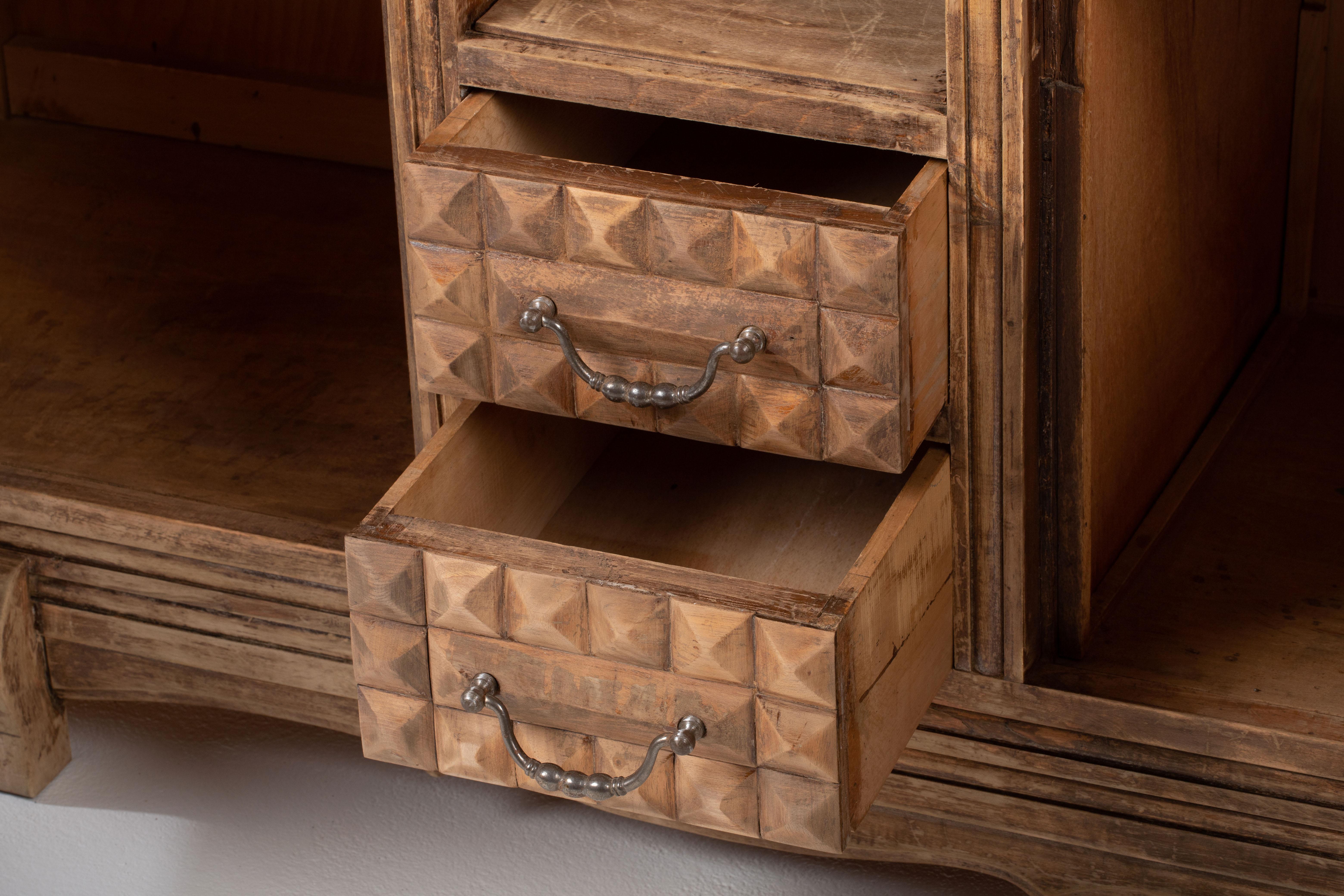 Credenza, solid oak, France, 1940s, after Charles Dudouyt.
Large Art Deco Brutalist sideboard. 
The credenza consists of two lateral storage facilities and covered with very detailed designed doors and in the center two drawers and a niche.
 Nice