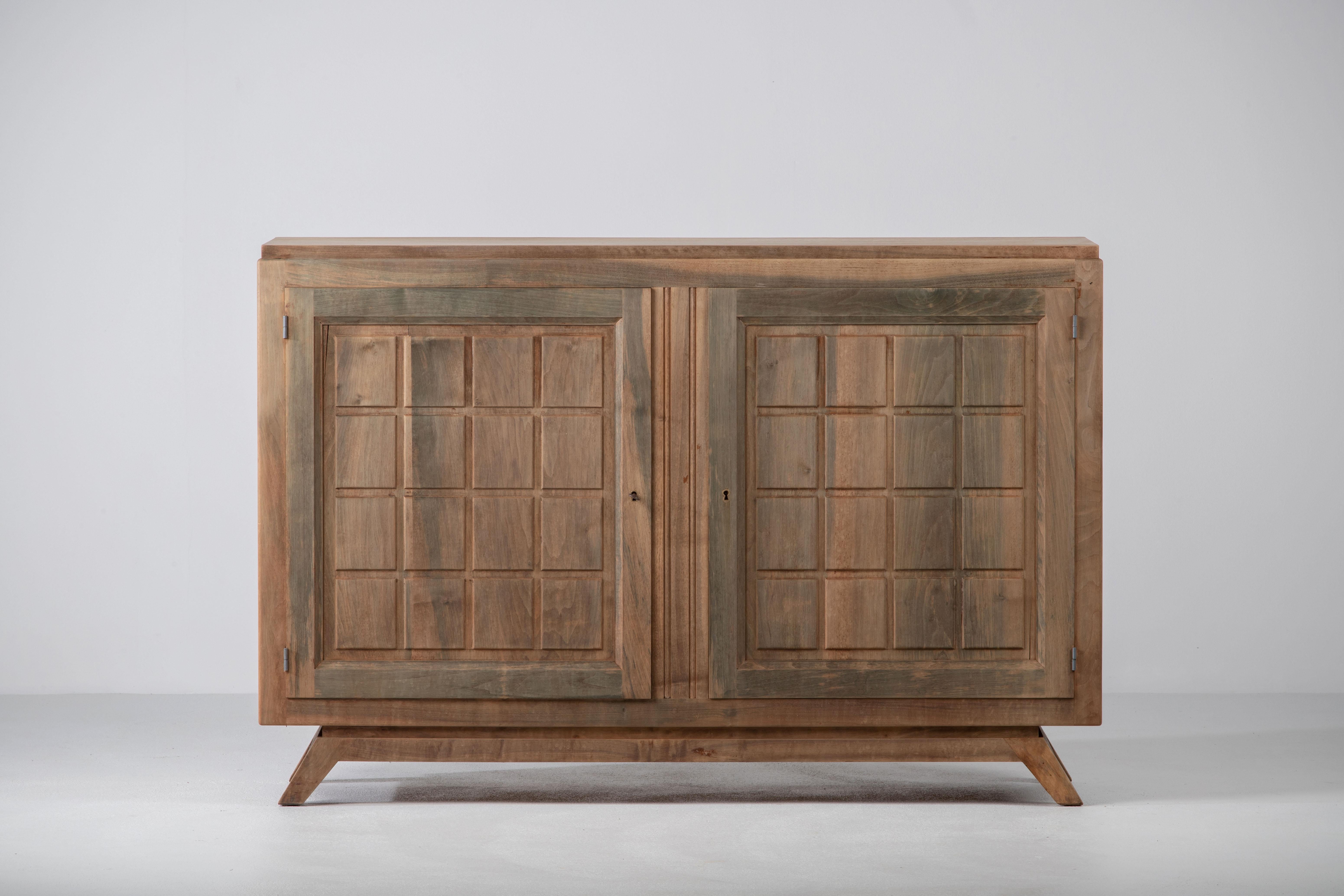 Credenza, solid oak, France, 1940s, after Charles Dudouyt.
Large Art Deco Brutalist sideboard. 
The credenza consists of two storage facilities and covered with very detailed designed doors.
 Nice patina.