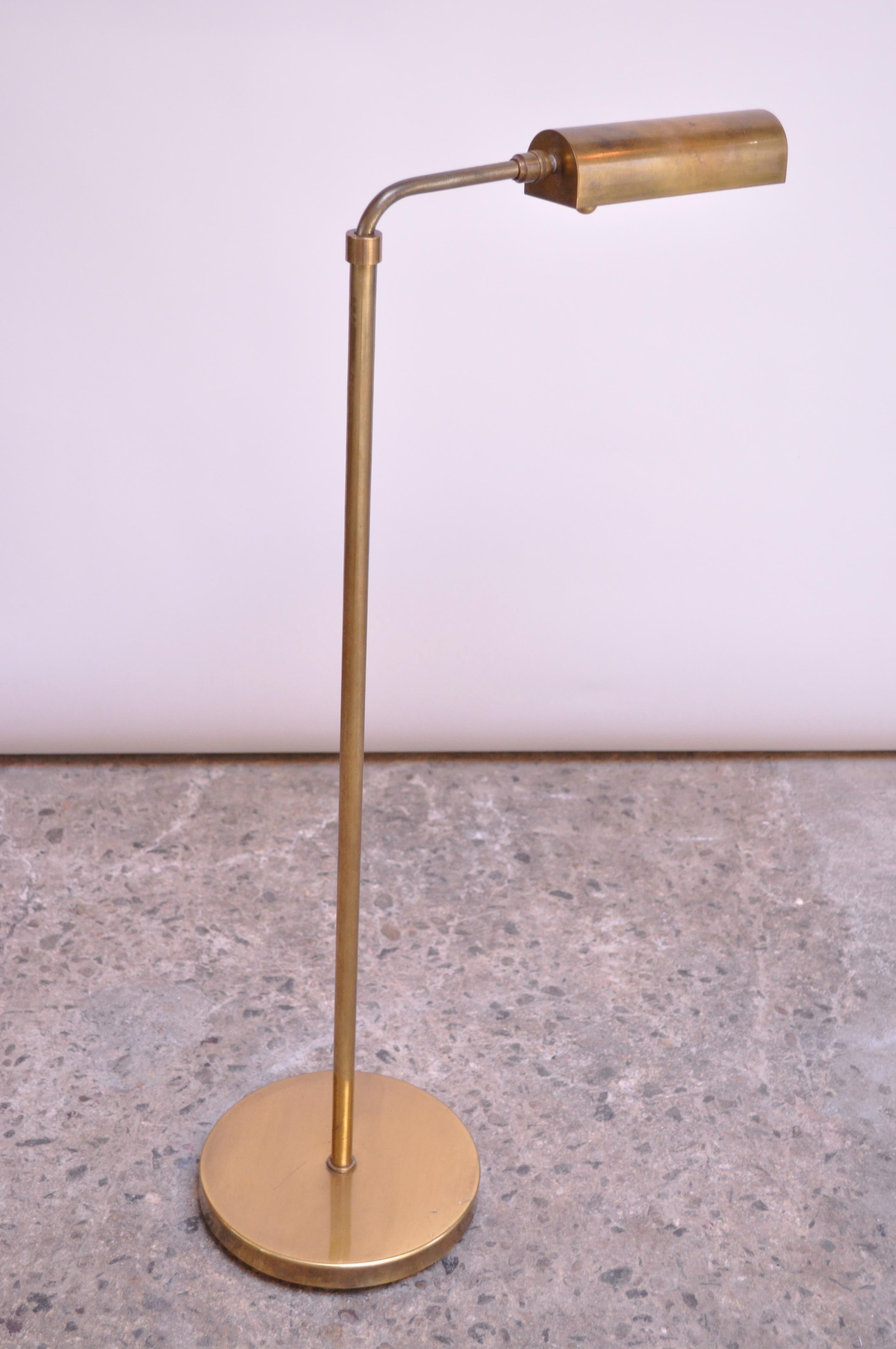 This floor lamp was designed by Chapman in the 1970s combining Industrial and modern design. Comprised entirely of brass this piece also features the signature bronze finish and dimmer 'ball' knob. The shade is fully adjustable, offering full 360