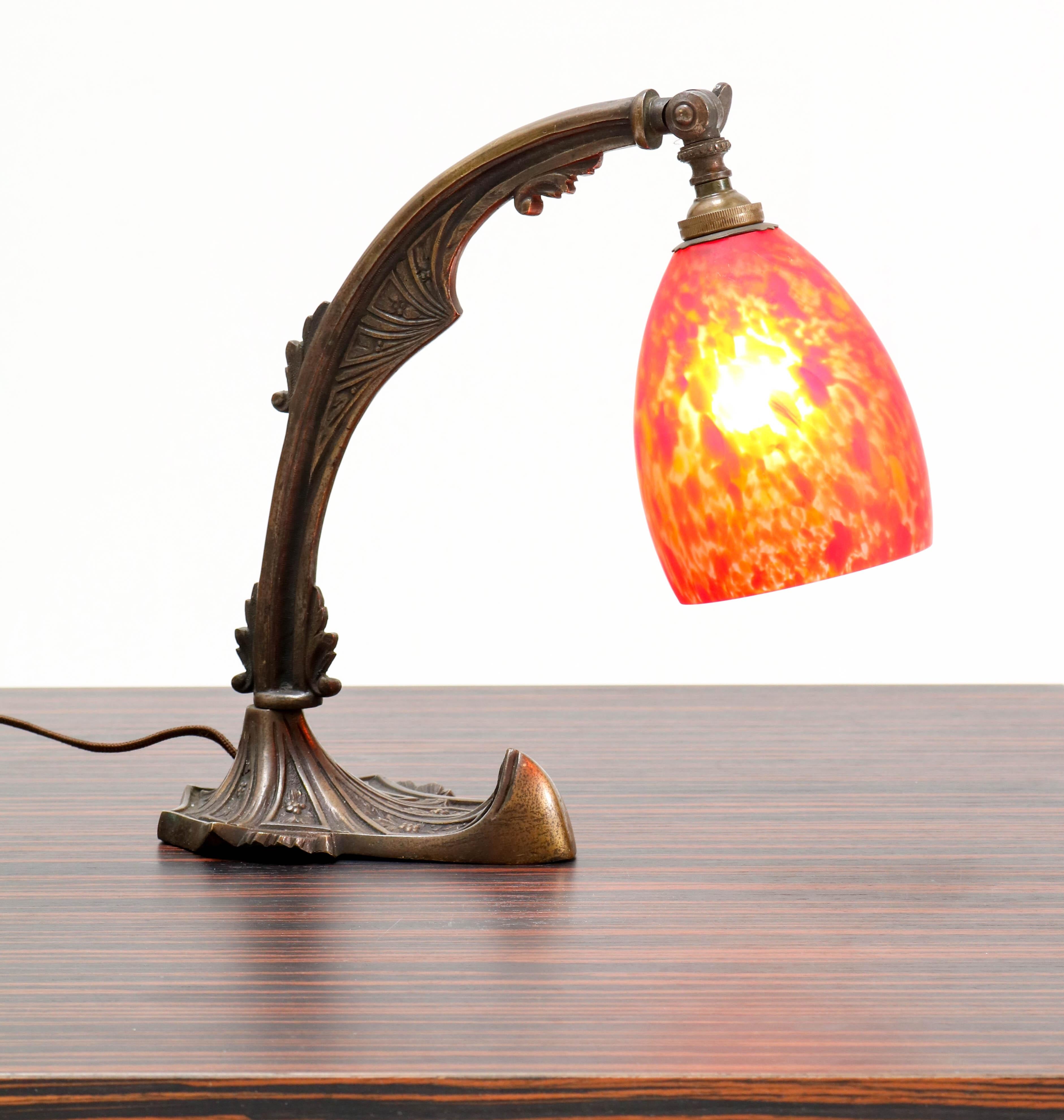 Stunning Art Deco Amsterdam School table lamp.
Striking Dutch design from the 1920s.
Solid patinated brass with glass shade.
Rewired with one socket for a B 27 light bulb.
In very good condition with a beautiful patina.