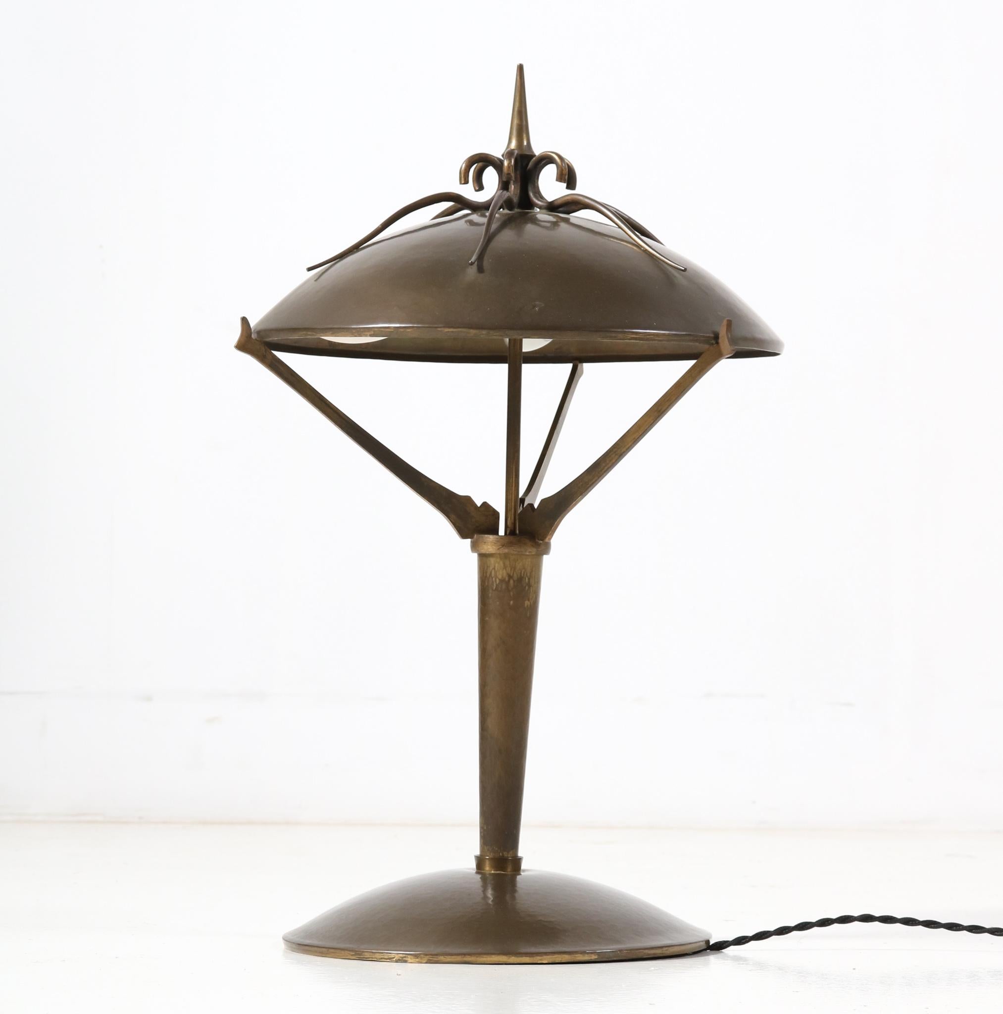 Magnificent and rare Art Deco Amsterdamse School table lamp or desk lamp.
Design in the style of the Gebroeders Reens Amsterdam.
Striking Dutch design from the 1930s.
Patinated brass frame with original patinated brass shade.
Rewired with three