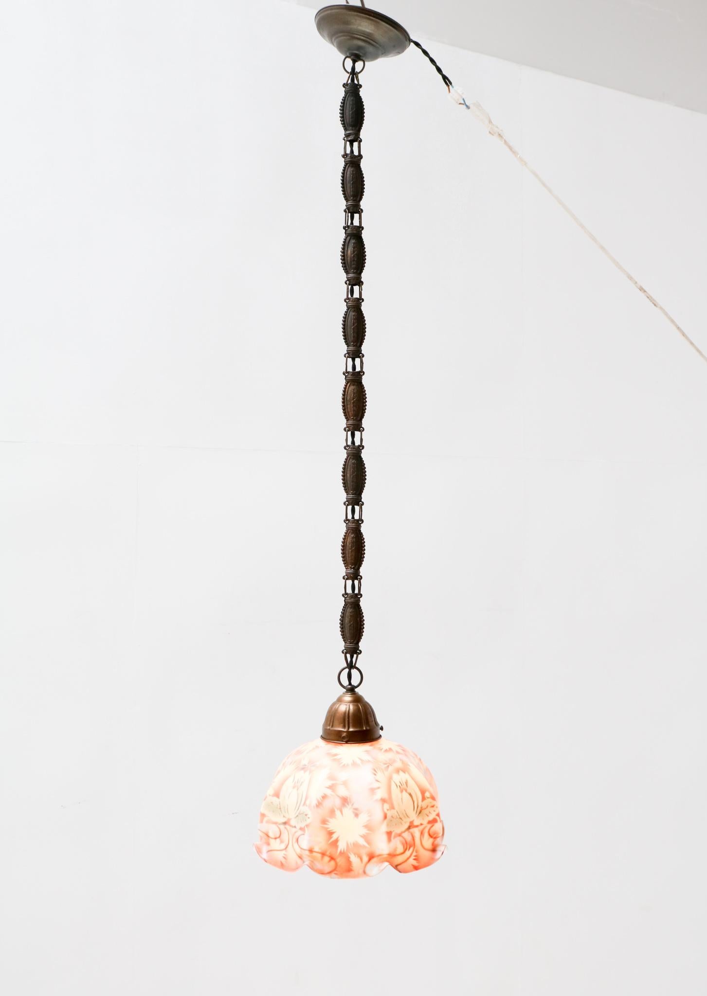 Stunning and elegant Art Nouveau pendant light.
Striking Dutch design from the 1900s.
Patinated brass with original multi-colored glass shade.
Rewired with original socket for E-27 light bulb.
This wonderful Art Nouveau pendant light is in very