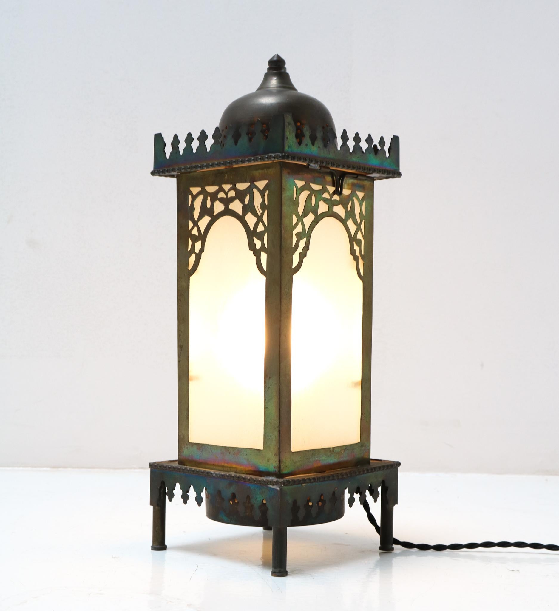 Stunning and rare Arts & Crafts Art Nouveau table lamp.
Striking Dutch design from the 1900s.
Patinated brass frame with original glass shades.
Rewired with original socket for E-14 light bulb.
This wonderful Arts & Crafts Art Nouveau table lamp