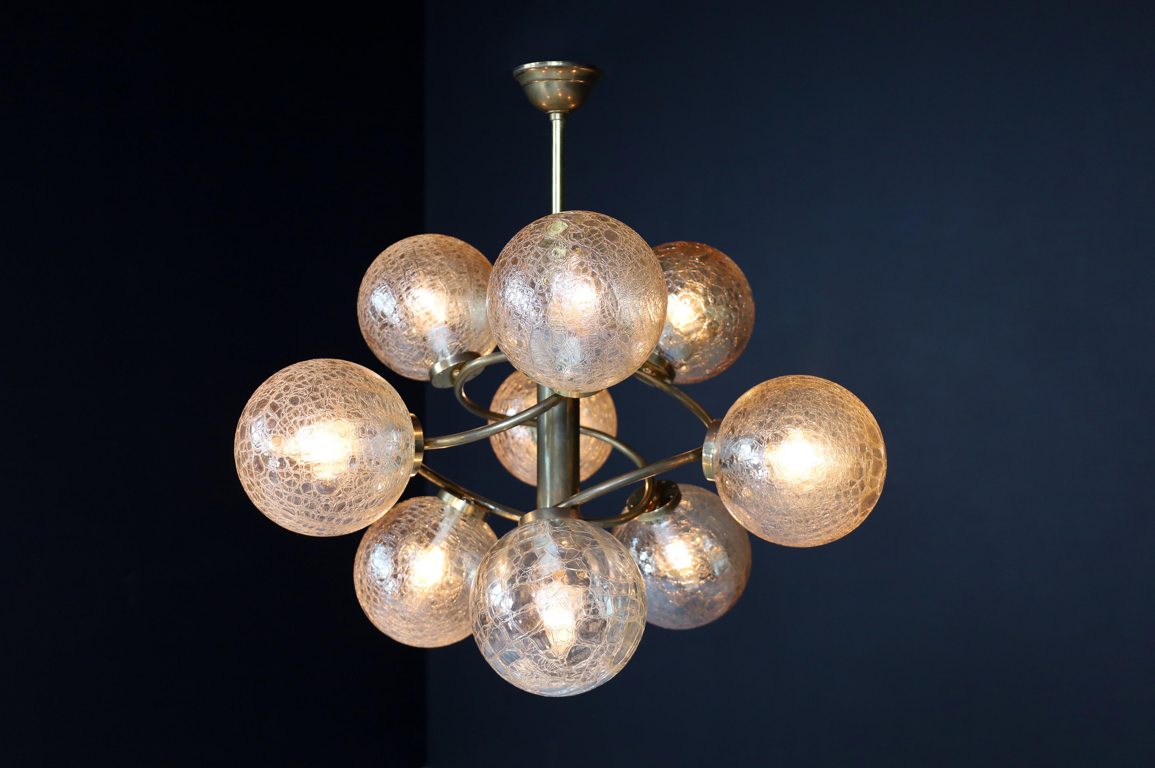 Patinated brass chandelier wit nine amber-colored globes, Germany 1960s.

A chandelier with a patinated brass fixture was made and designed in Germany in the 1960s. Completed with the nine structured amber-colored globes and brass frame wil this