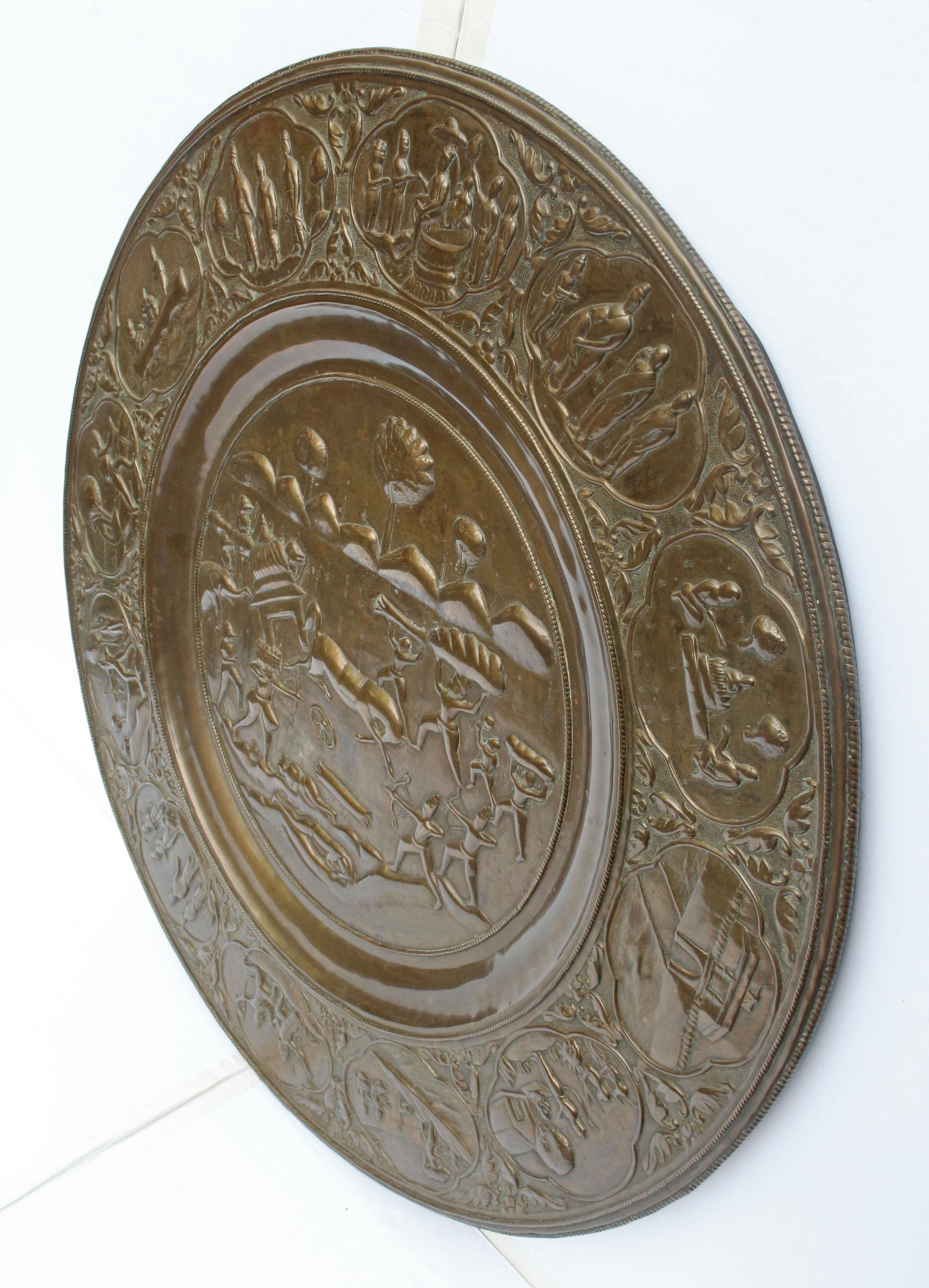 A splendid Indian or Siamese patinated brass disc, the scenes depicting the epic poem of the Hindu deity Rama. If Siamese, it depicts the Annanese adoption of the Ramayana in the late 18th drama depicting the event. The central panel is war waged by