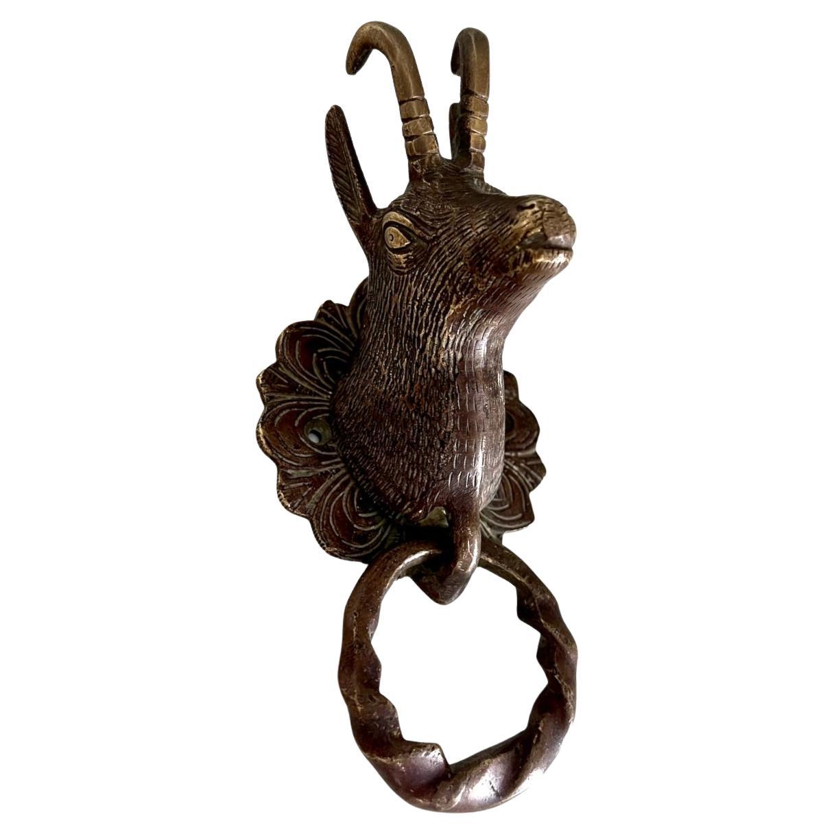 Let this beautiful bronze goat guard your entryway. Goats are strong and resilient, with a gentle side. The Chinese Zodiac notes goat's ability to persevere through any difficulty because of their tolerance and motivation. 

 This door knocker