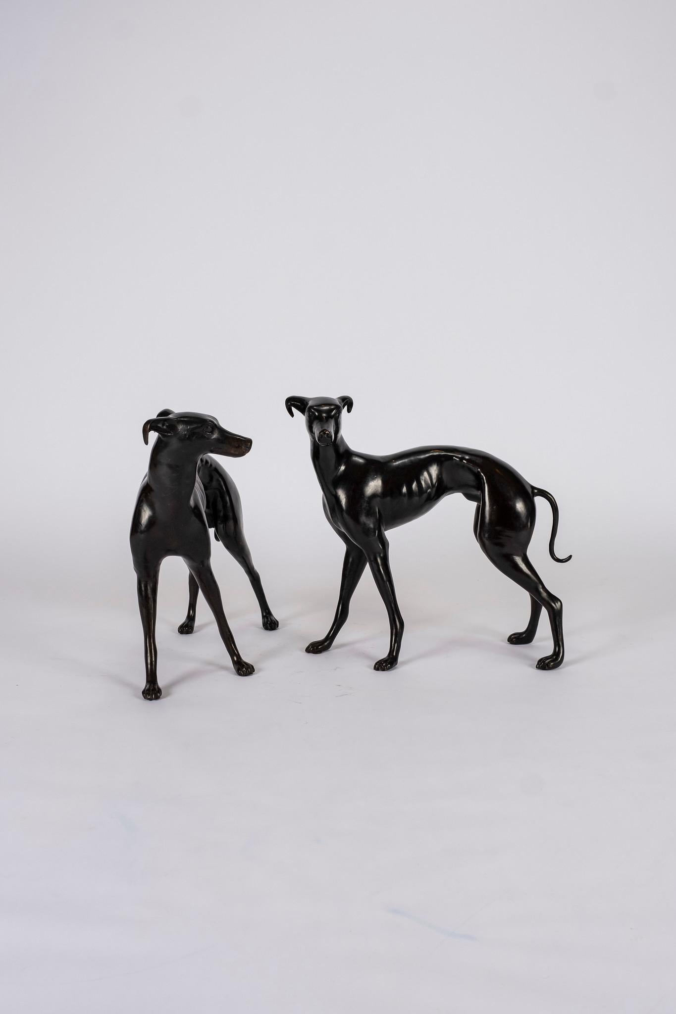 A pair of 20th century patinated brass greyhound dogs.