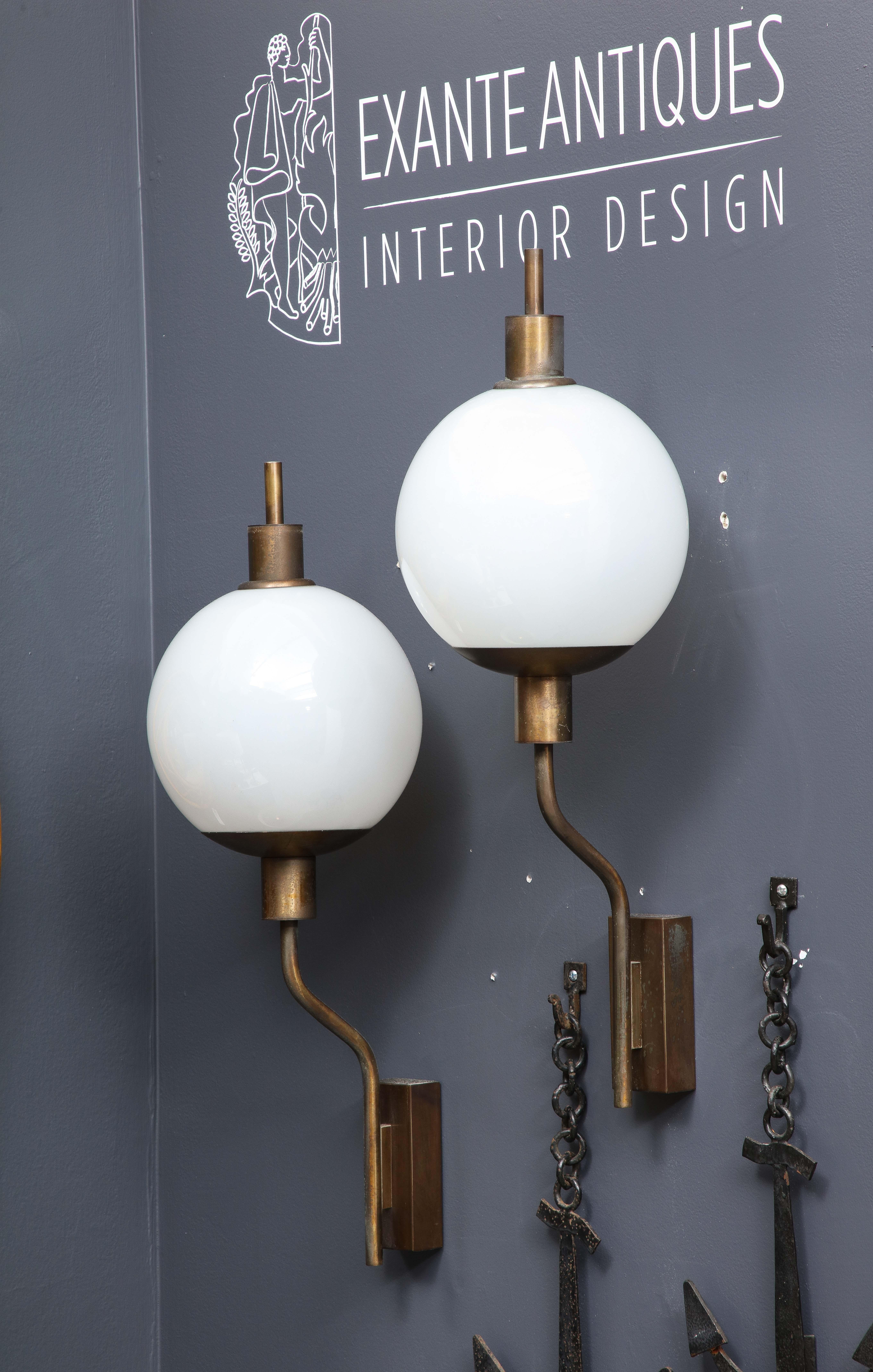 Rare pair of Italian Mid-Century Modern sconces. Attributed to Luigi Caccio Dominioni. 
Price includes rewiring for US.
These wall lights will ship from France and can be returned to either France or to a LIC NY location.
Price does not include