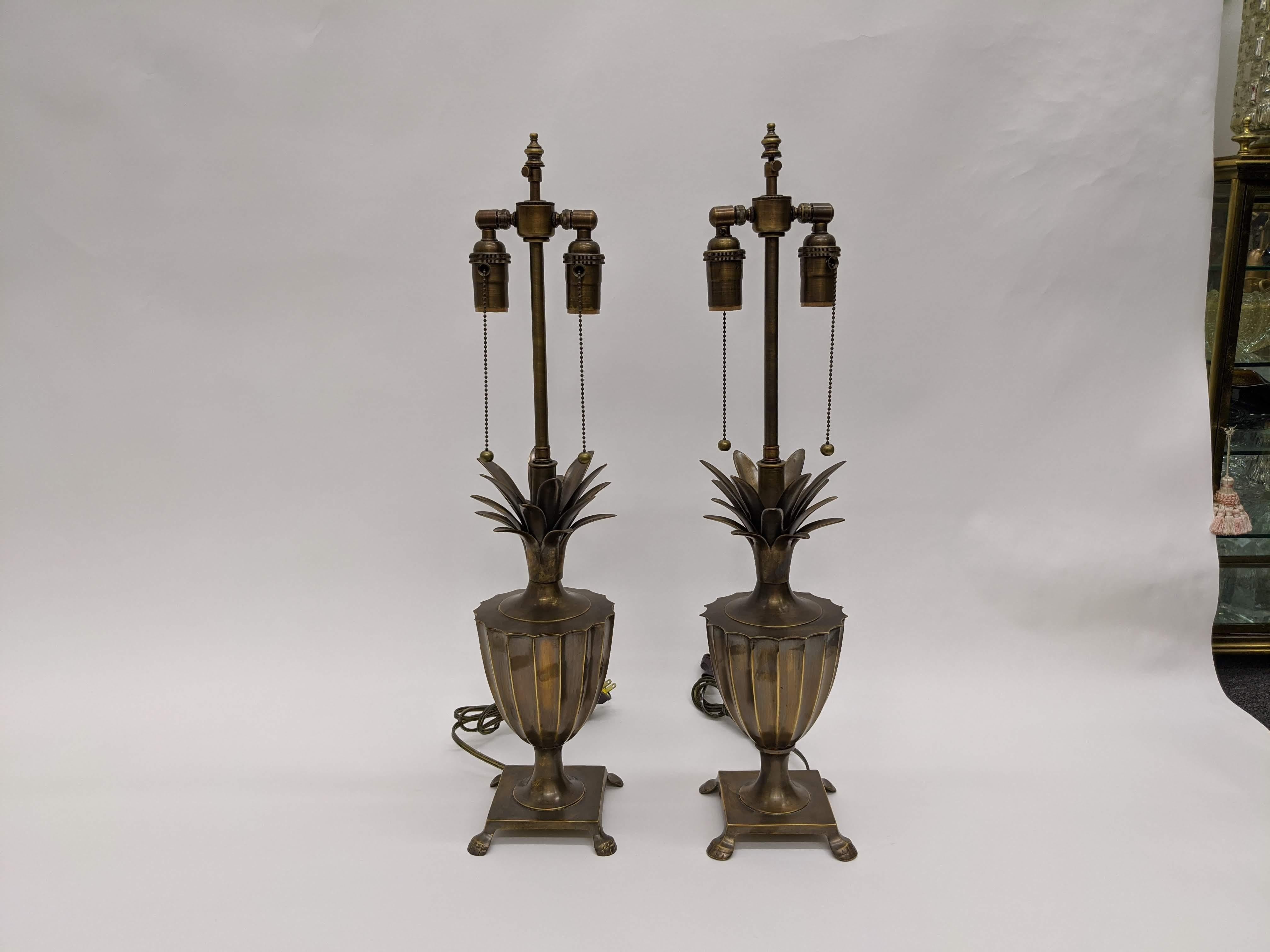Midcentury patinated solid brass fluted pineapple urn lamps with square platform footed base. Double socketed brass hardware with pull chains.