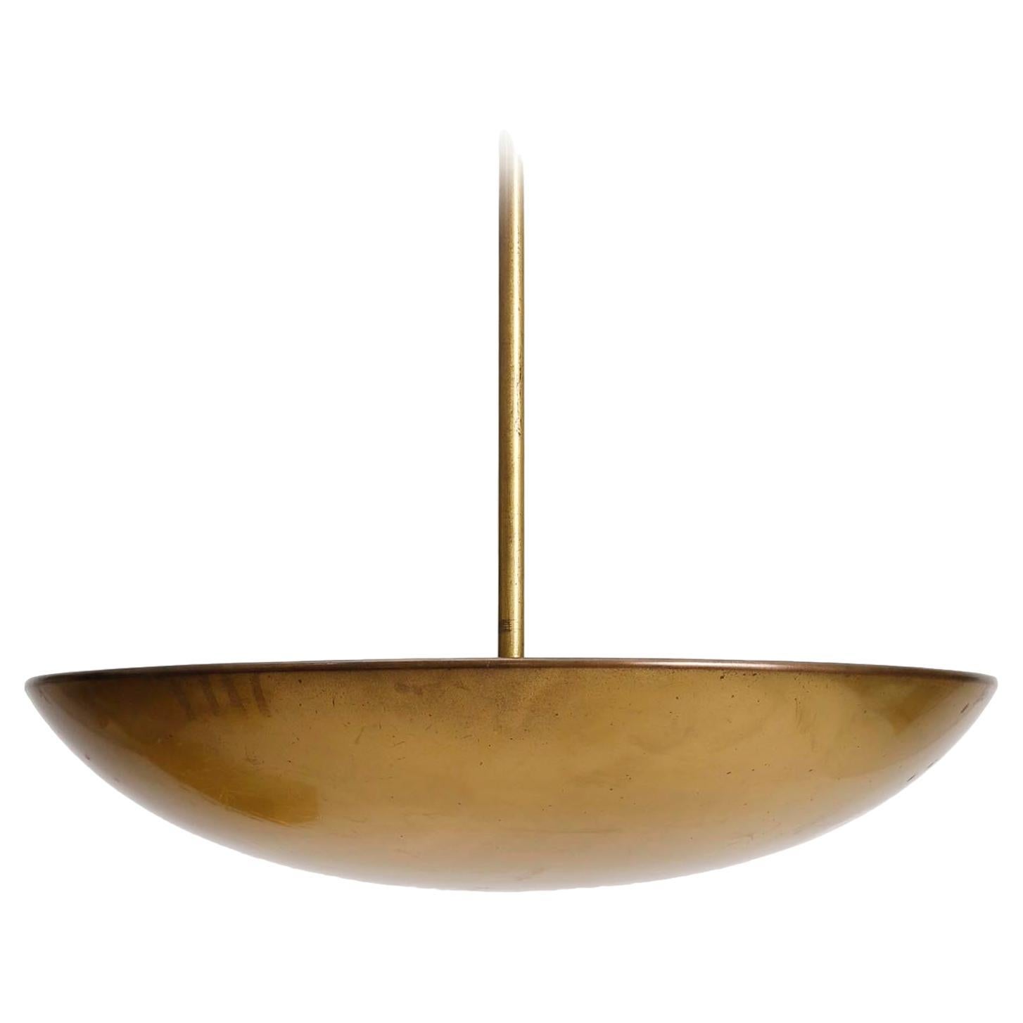 A large polished brass bowl up light chandelier / pendant light by J.T. Kalmar, Austria, manufactured in midcentury, circa 1960 (late 1950s or early 1960s).
The fixture is made of solid polished brass which has an aged surface in a rich and warm