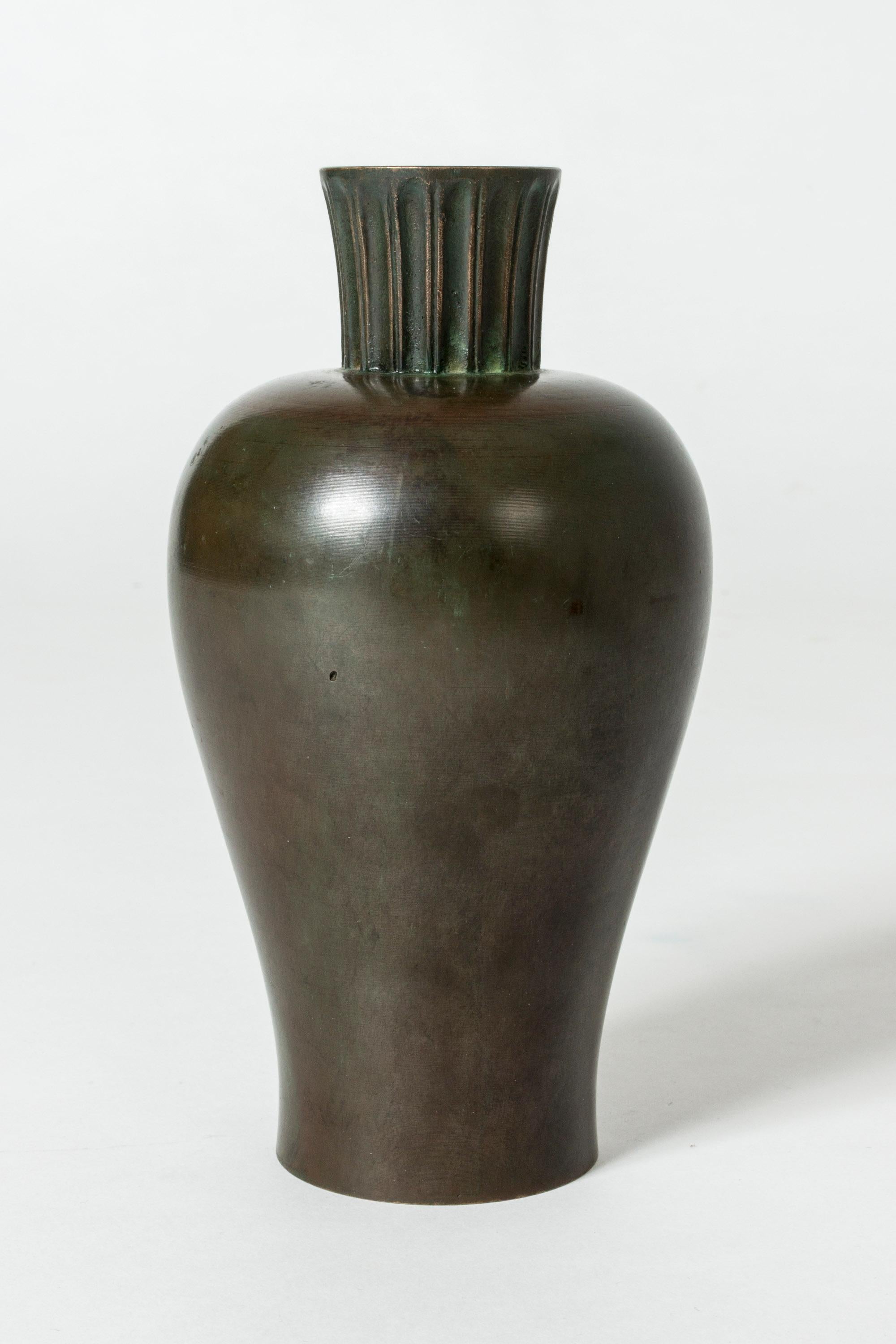 Patinated bronze vase from GAB in a smooth, bulbous form. Nozzle with embossed stripes.