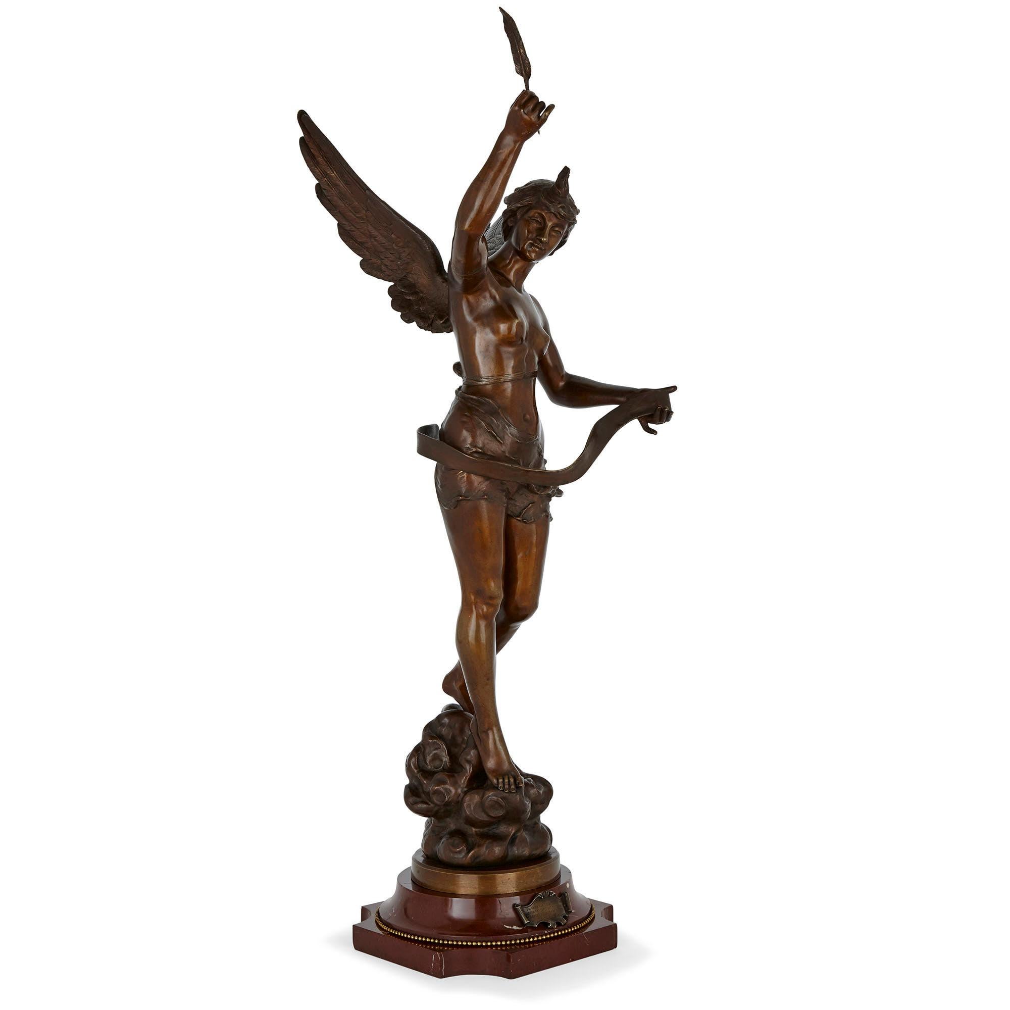 This patinated bronze sculpture, by the French sculptor Ernest Justin Ferrand, features a female winged figure holding a quill pen and an unfurled scroll of paper. She stands naturalistically, her posture in a classical contrapposto, upon a red