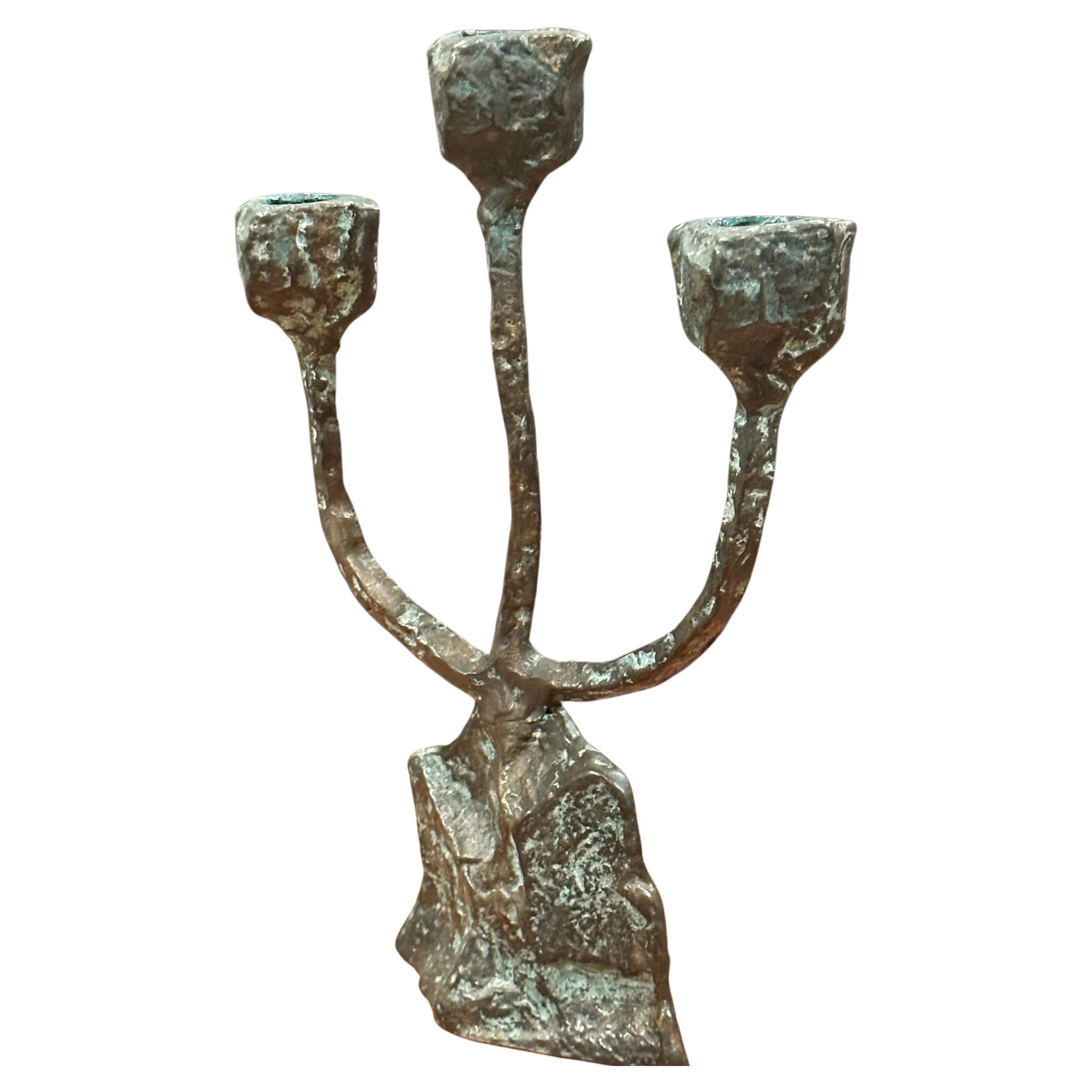 Patinated bronze brutalist triple candelabra in the style of Paul Evans, circa 1970s.  This unique looking piece is in very good vintage condition with a wonderful patina and measure 7
