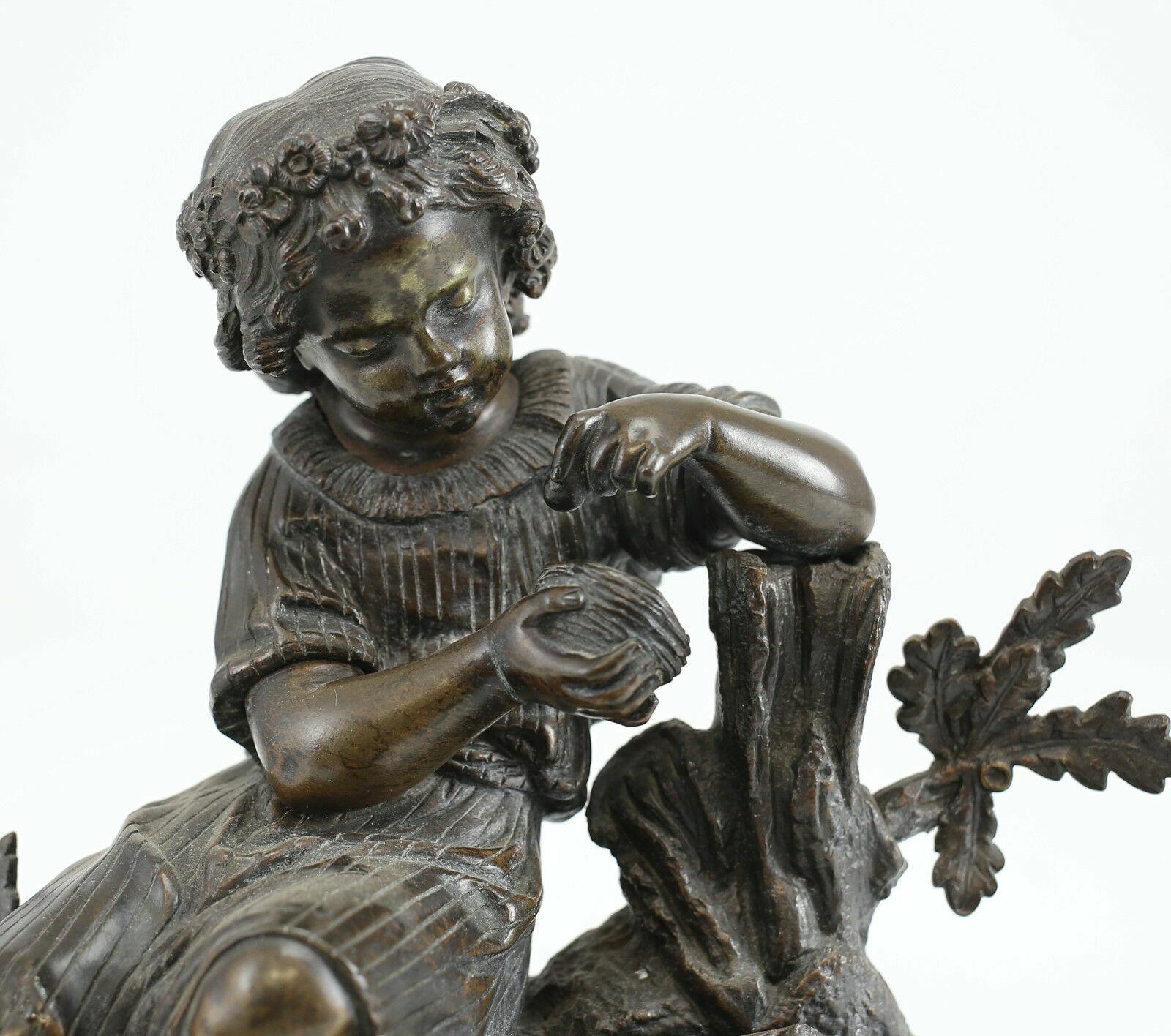 Patinated bronze figurative sculpture girl with bird egg & nest, 19th century 

This beautiful Sculpture depicts a girl gently picking up an egg in a nest of birds with her basket of delicately forgotten flowers spilling over beside her.