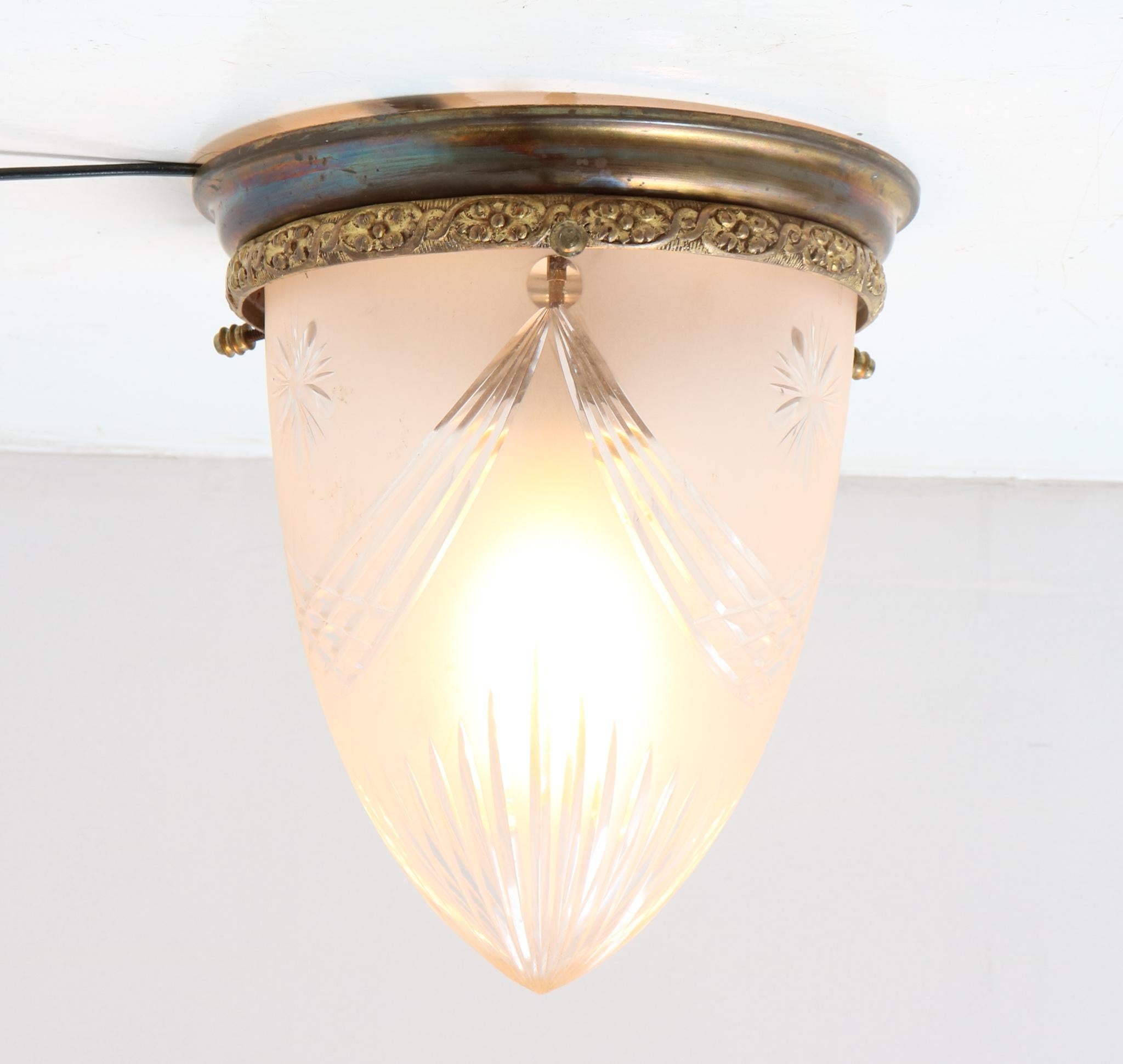 Magnificent and rare Art Nouveau flush mount ceiling light.
Striking French design from the 1900s.
Patinated bronze with original cut blown glass shade.
This wonderful Art Nouveau flush mount ceiling light is rewired with one original
socket for