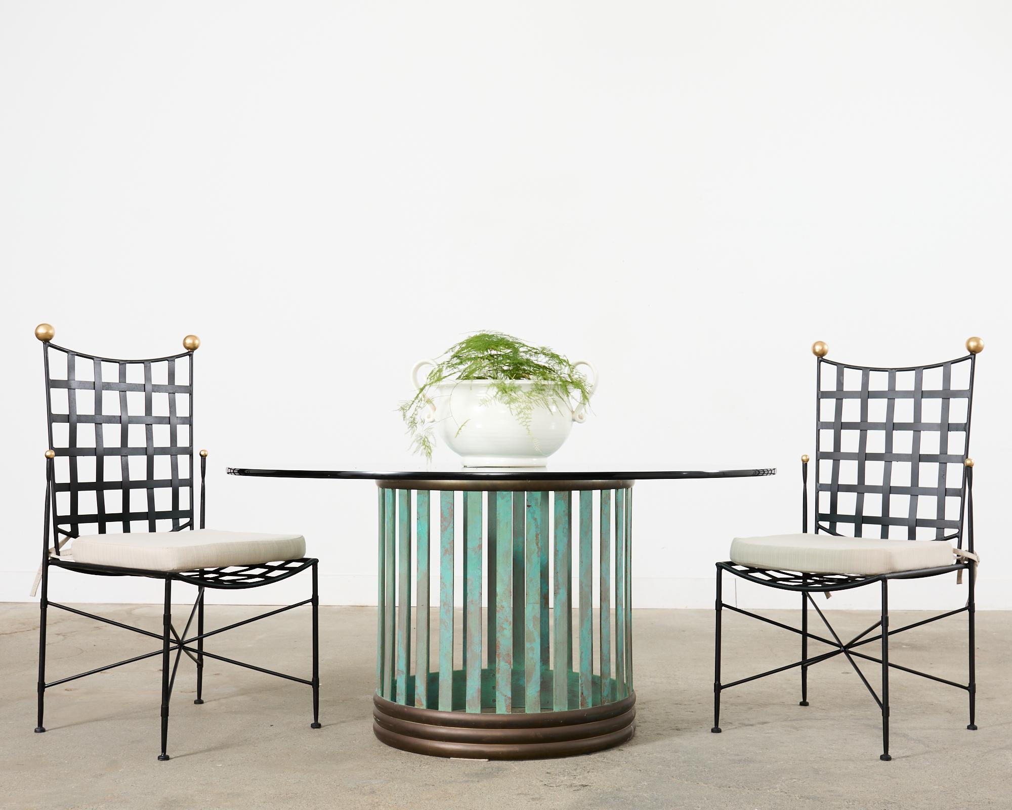 Magnificent mid-century modern French Industrial style patio and garden dining table or center table crafted from cast bronze. The table base measures 28.25 inches in diameter and height and is topped with a thick pane of round glass measuring 60