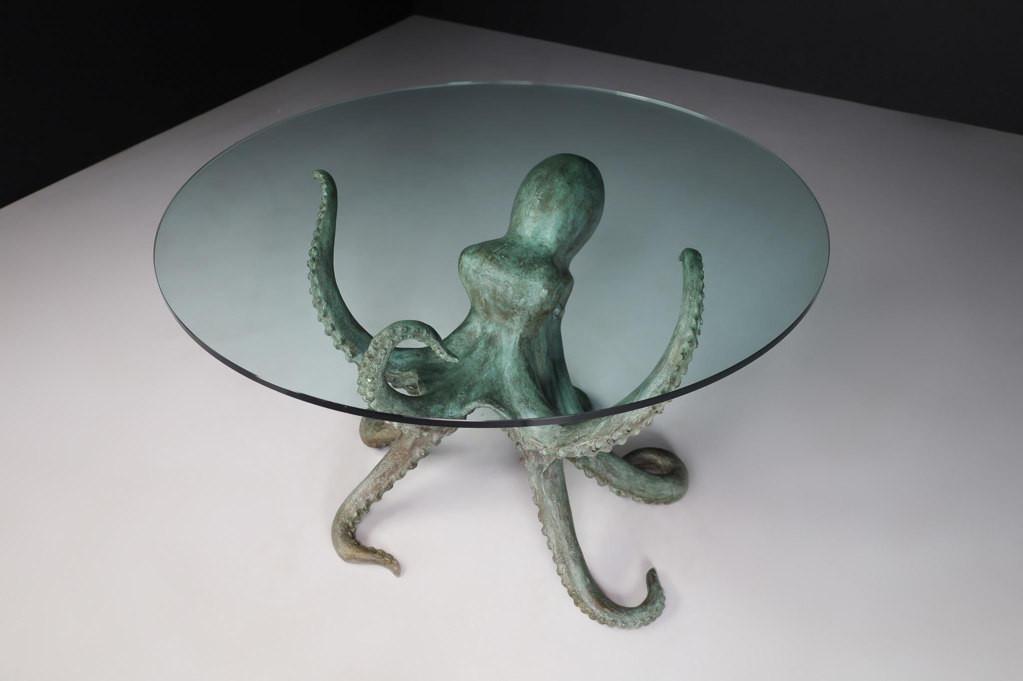 Patinated Bronze Octopus Table or Sculpture, 1970s Italy

This fabulous dining table in the shape of an octopus is made in Italy. The base of the table is a bronze octopus with 3 tentacles propped up the glass top and 5 on the floor. Not only does