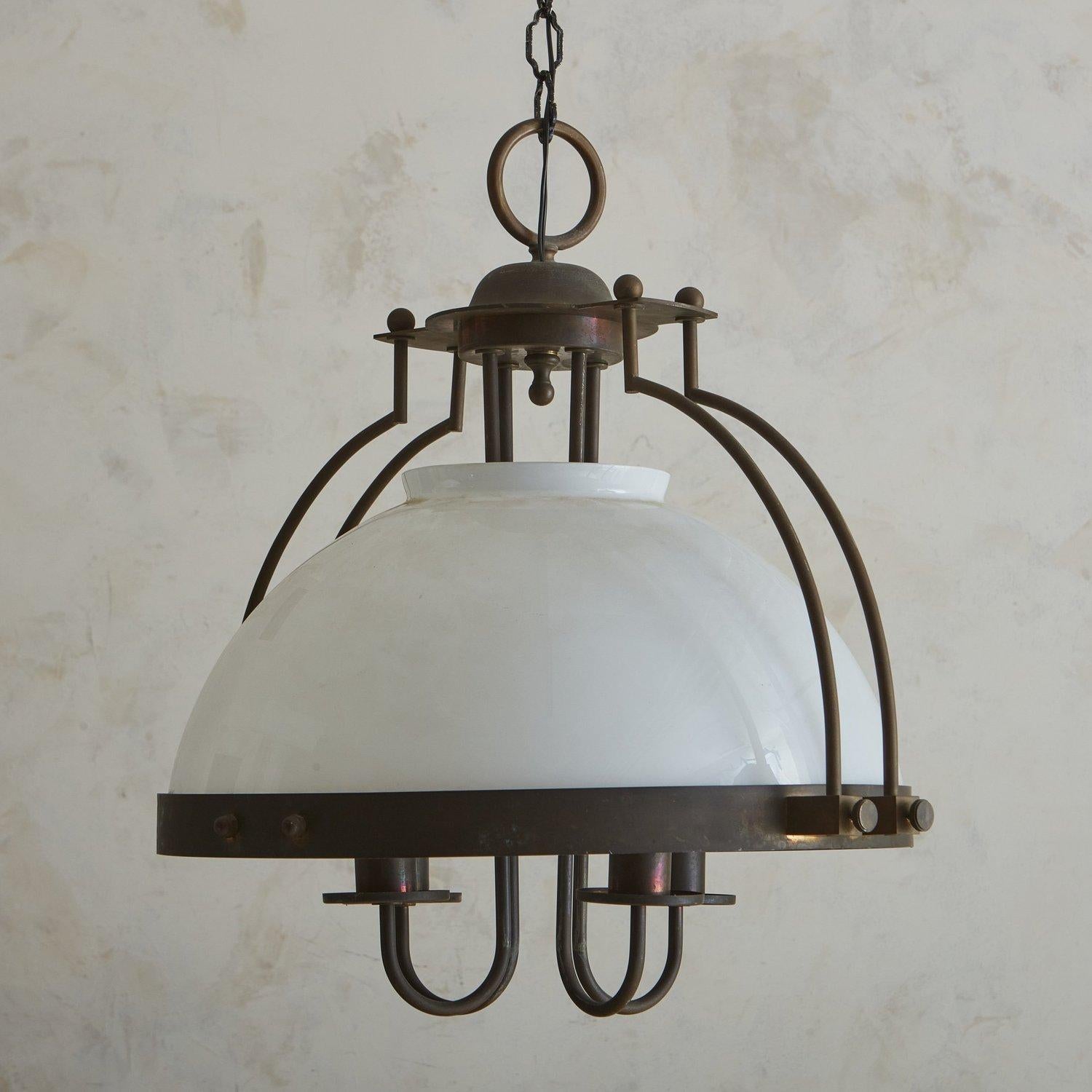 A 1970s French pendant light featuring an opaline glass dome shade, which is suspended from a patinated bronze cage frame. The frame has elegant curves, spherical finial details and industrial hardware. Four tubular, curved arms with bobeches hang
