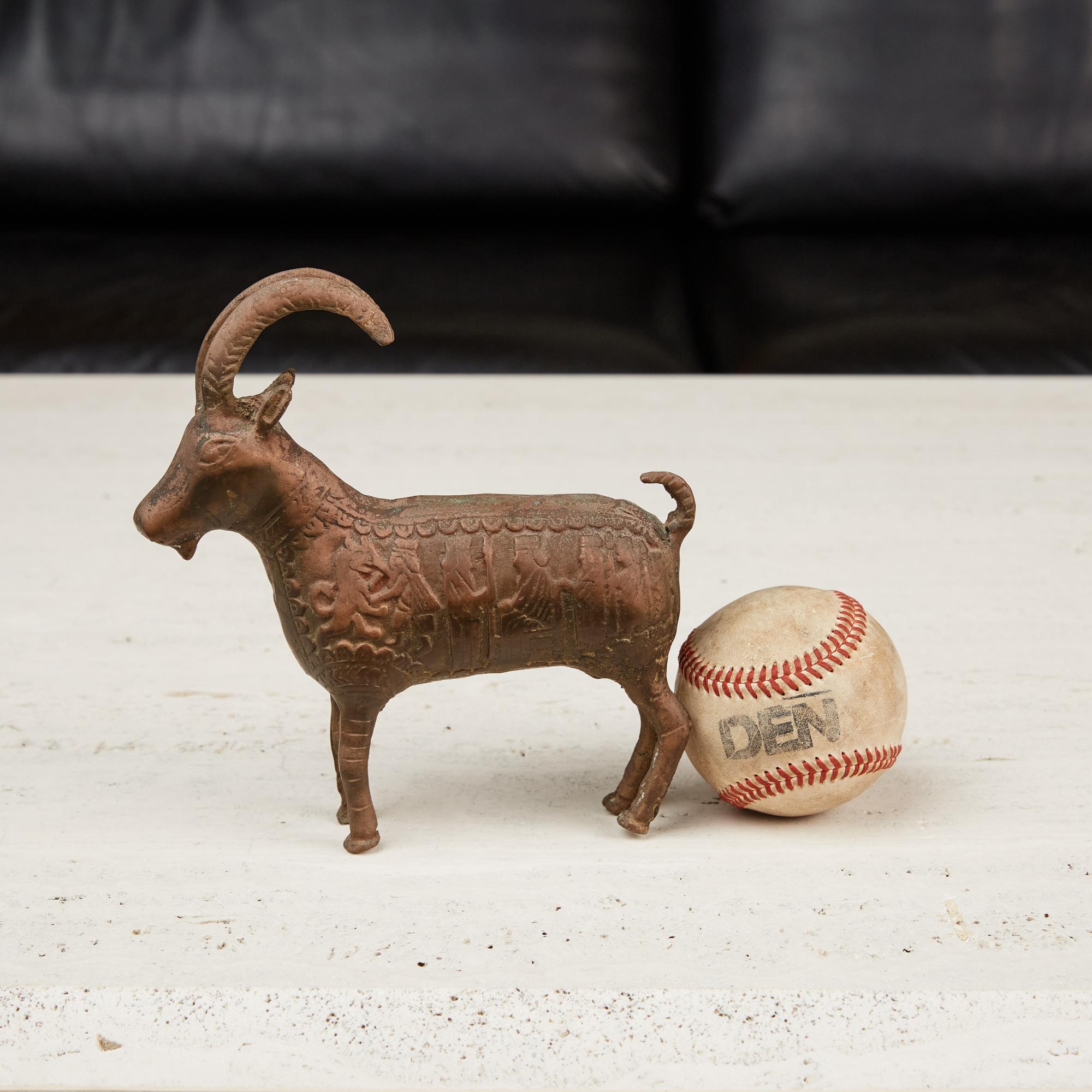 Patinated bronze ram figure featuring a hieroglyphic pattern on both sides of the body of the figure. It is the perfect accessory for your shelf or curio cabinet.

Dimensions: 6.75” width x 2” depth x 7” height.

Condition: Excellent vintage