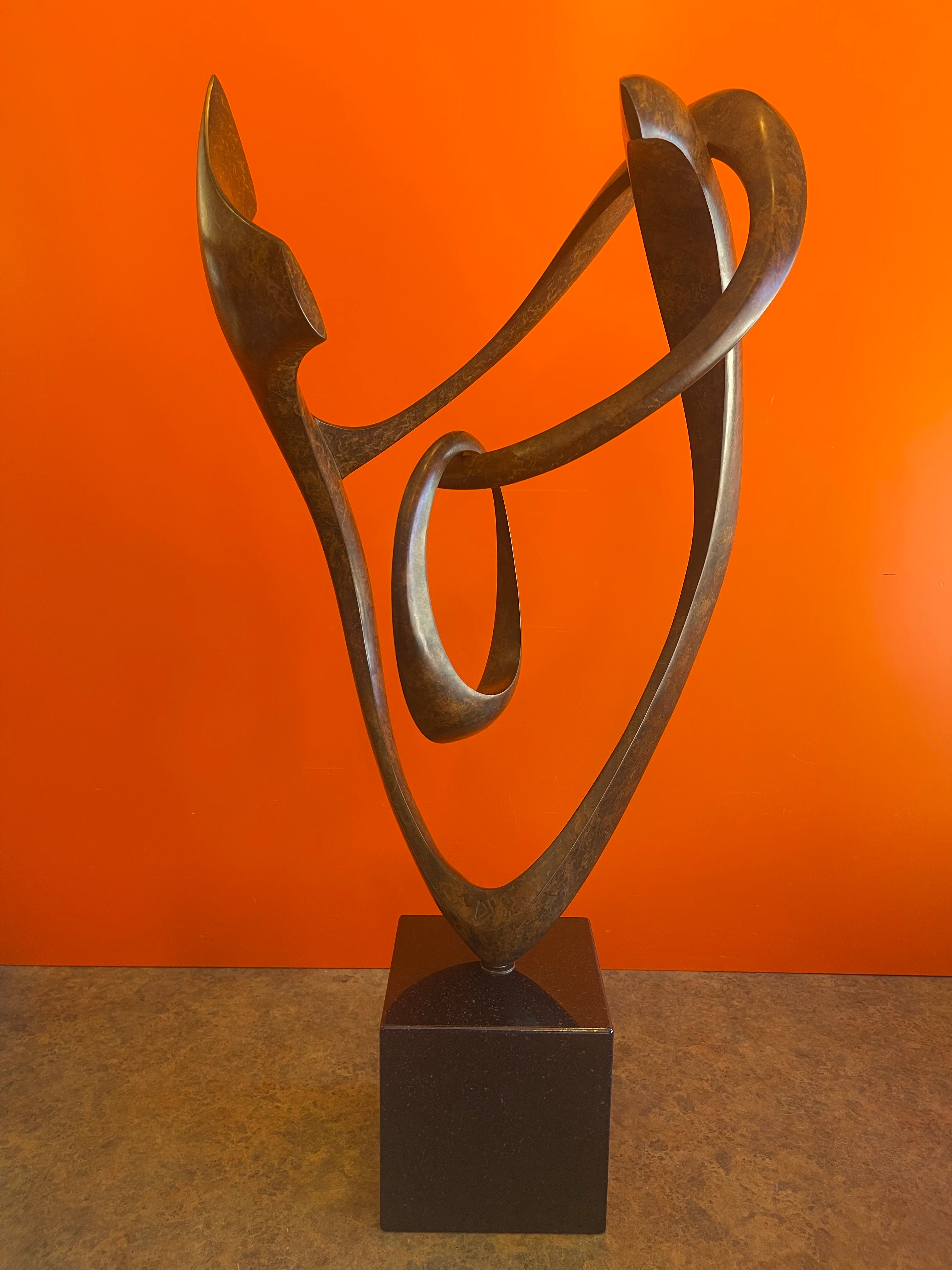 A very nice patinated bronze rotating abstract sculpture on black marble base entitled 