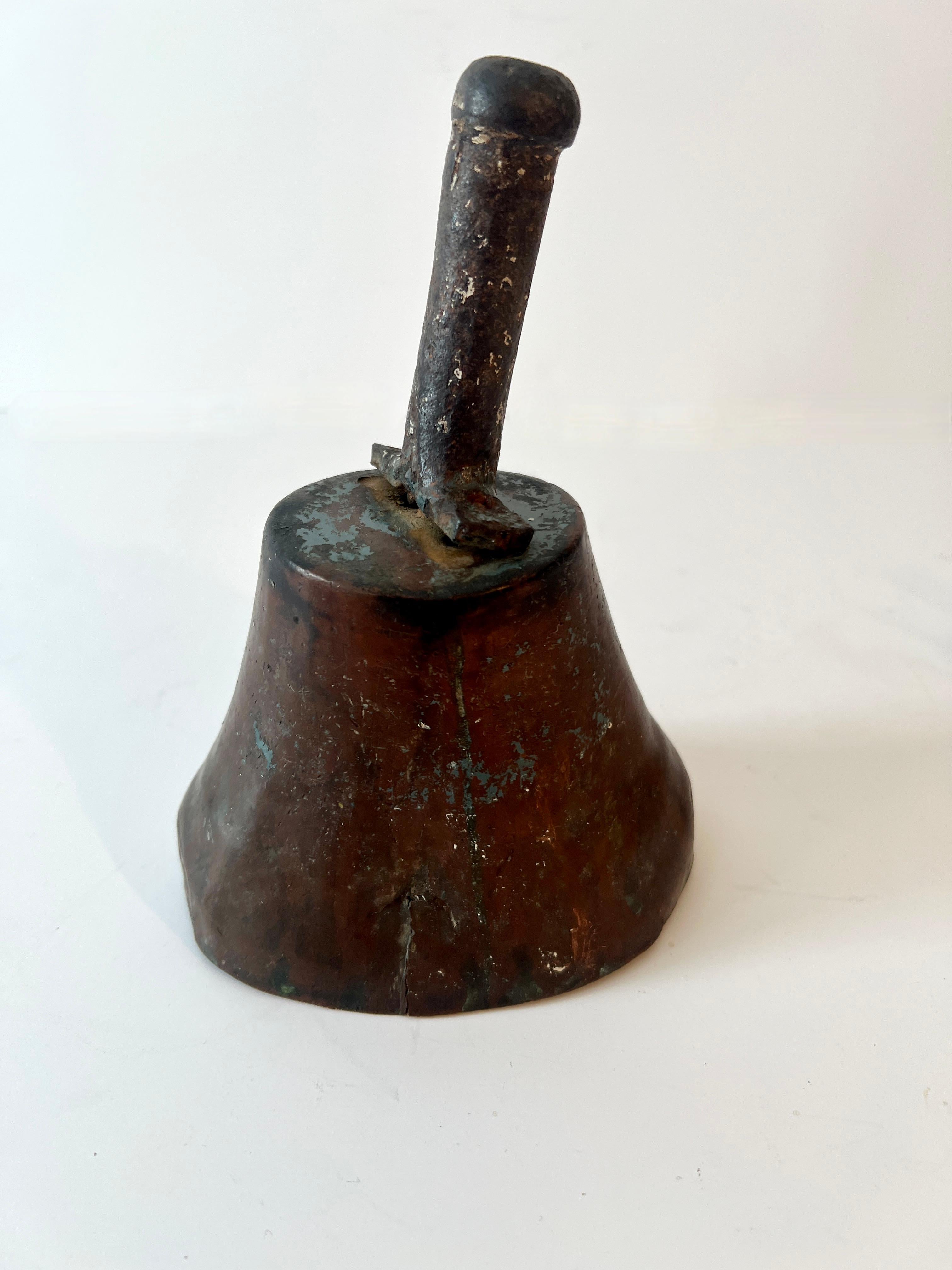 A wonderfully patinated school or town crier bell.  While it works great, it would be a terrific decorative piece, especially on a console table with a story of primitive items and books.

The bell is special due to it's age and a time that has gone