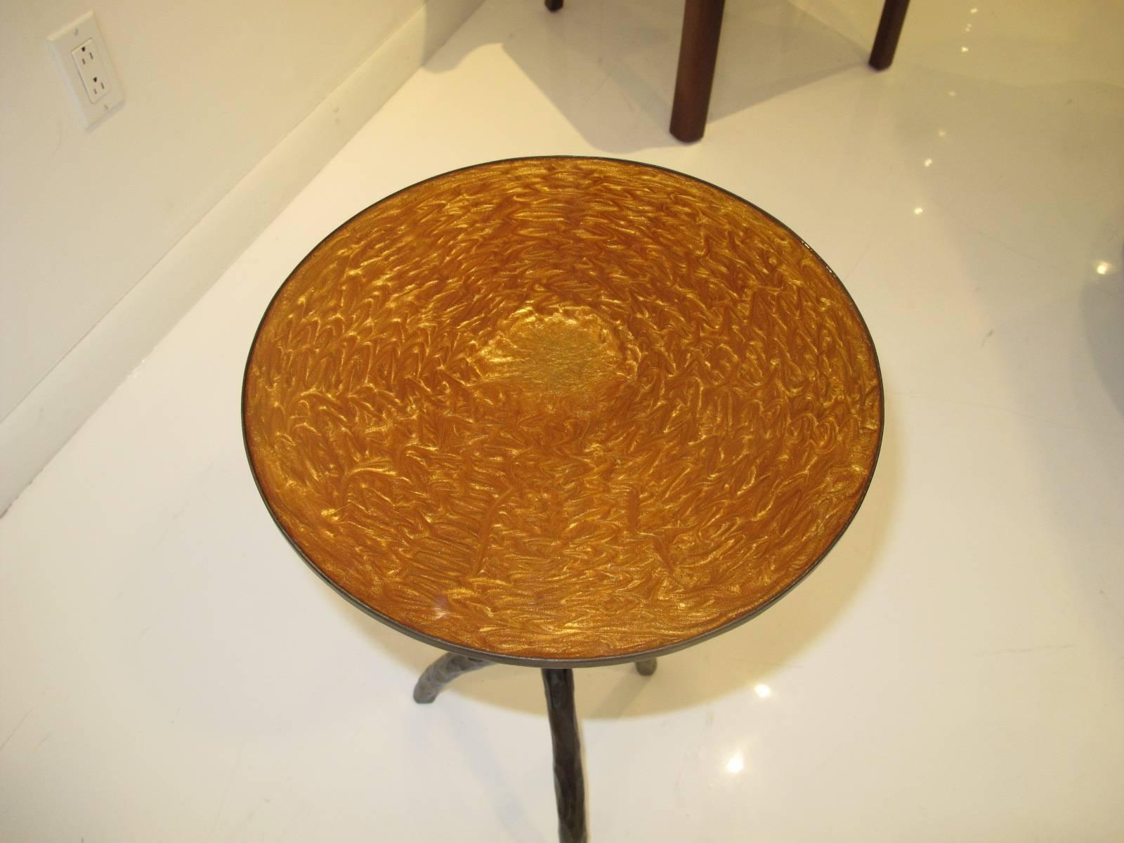 Patinated bronze circular sculptural cocktail table in the style of Christian Liaigre, the top inset with a gold color mottled resin top.