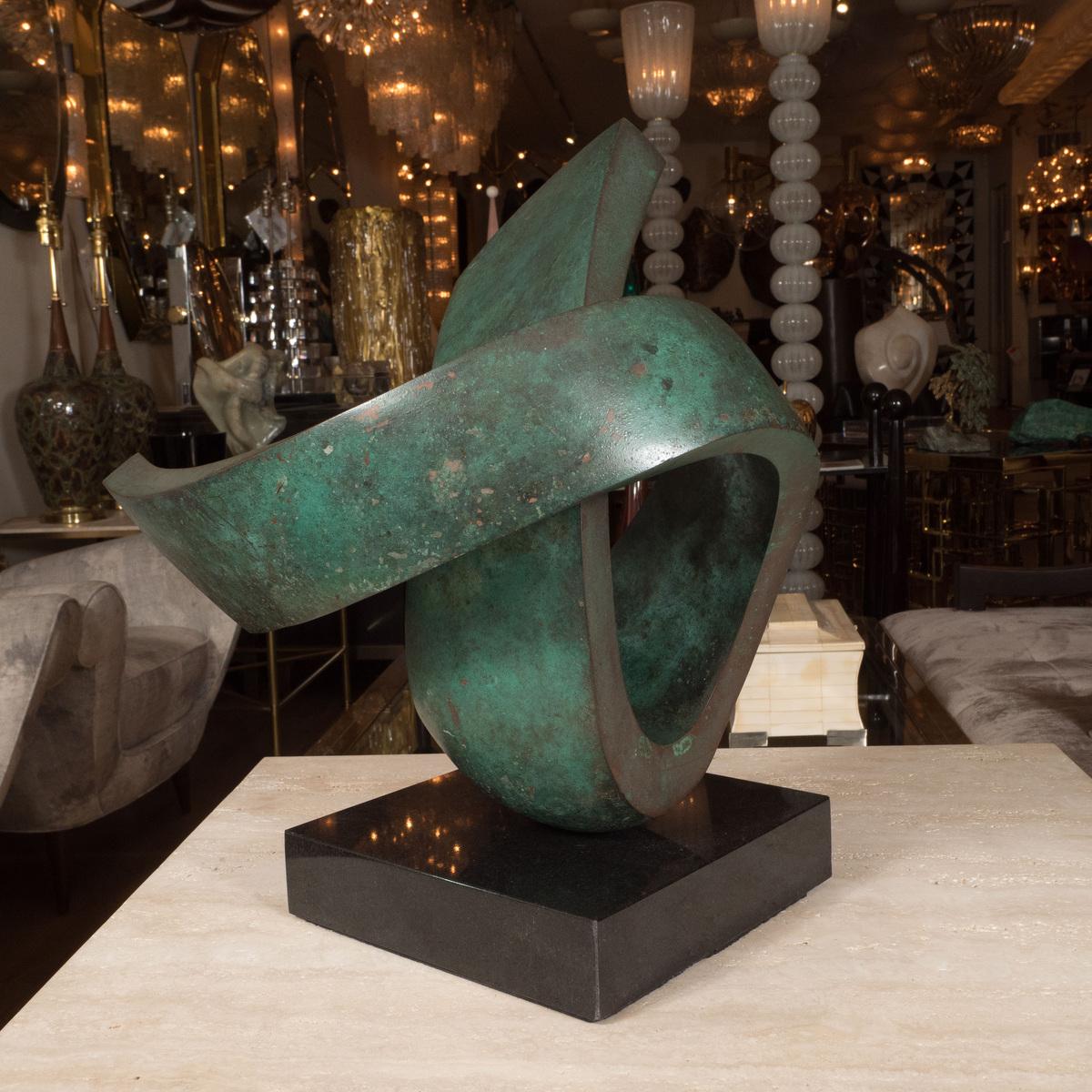 Patinated swirling bronze sculpture.