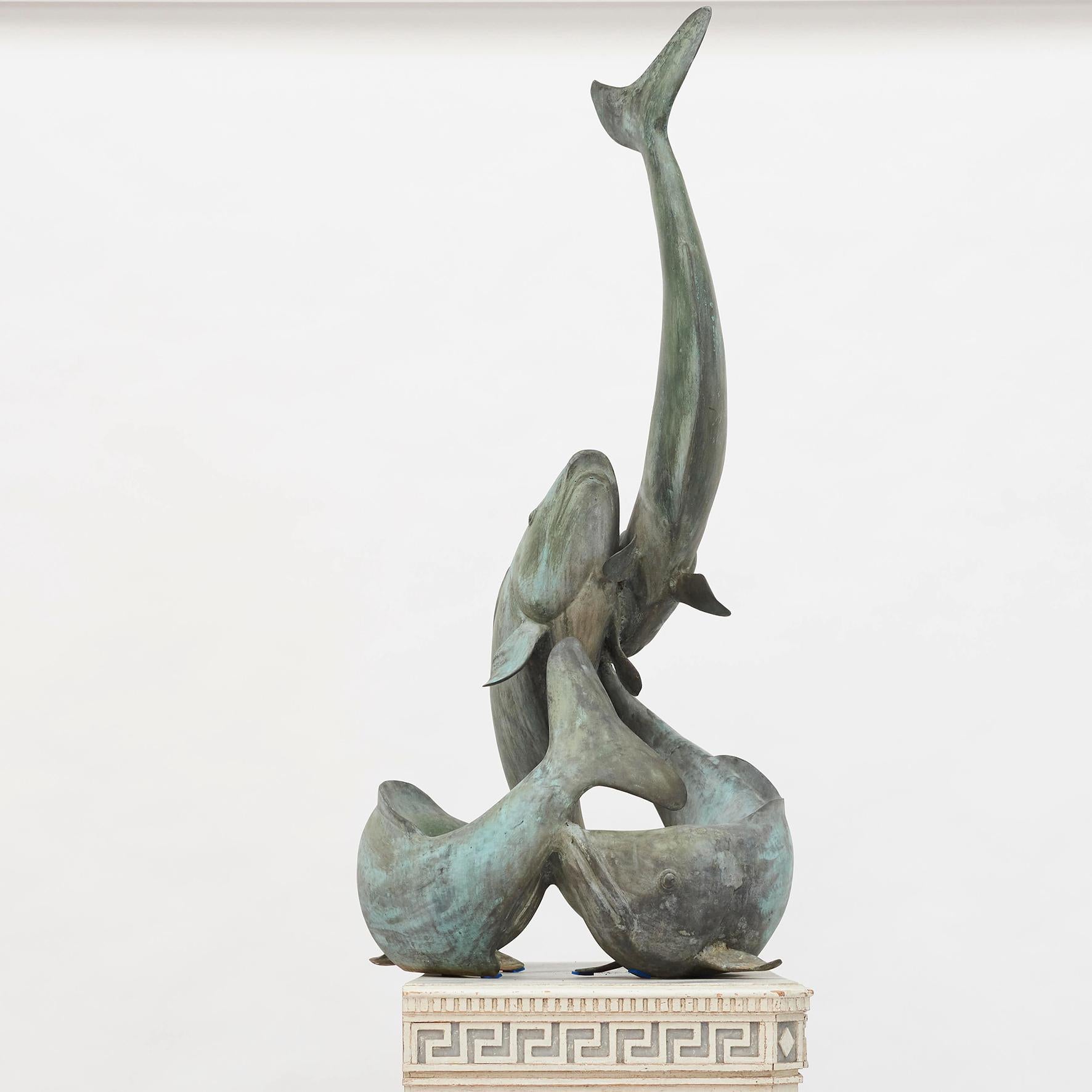 Patinated bronze sculpture in the form of 4 intertwined Koi carps. Probably a decoration from a carp pond. 20th Century