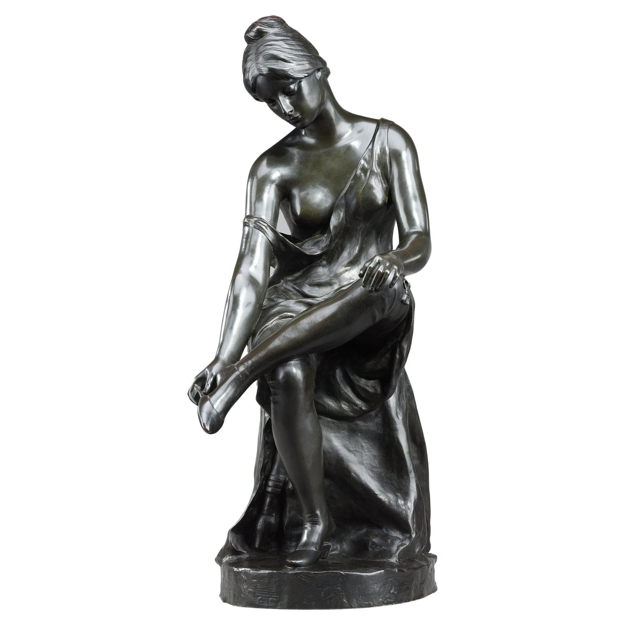 Patinated bronze sculpture, "Jeune femme se déchaussant", signed Malvina Brach