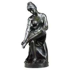 Antique Patinated bronze sculpture, "Jeune femme se déchaussant", signed Malvina Brach
