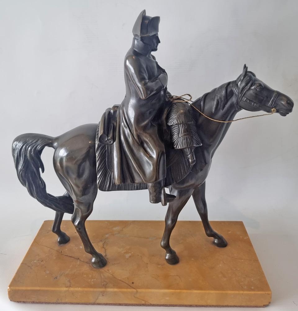 A fine patinated bronze sculpture of Napoleon Bonaparte on his horse Marengo. Set upon a sienna marble base.