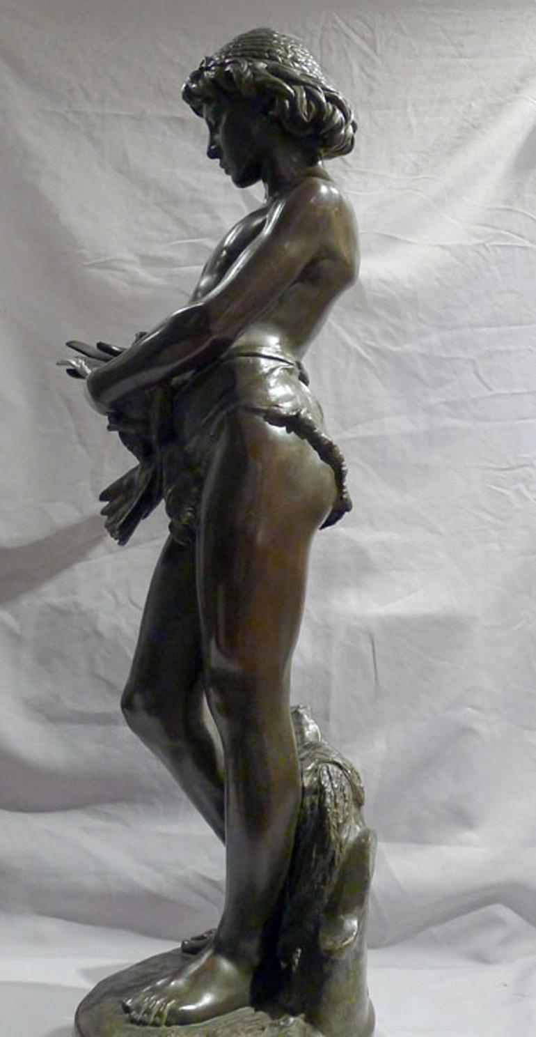 Patinated bronze sculpture of young boy trimming the wings of a dove by Gregoire For Sale 2