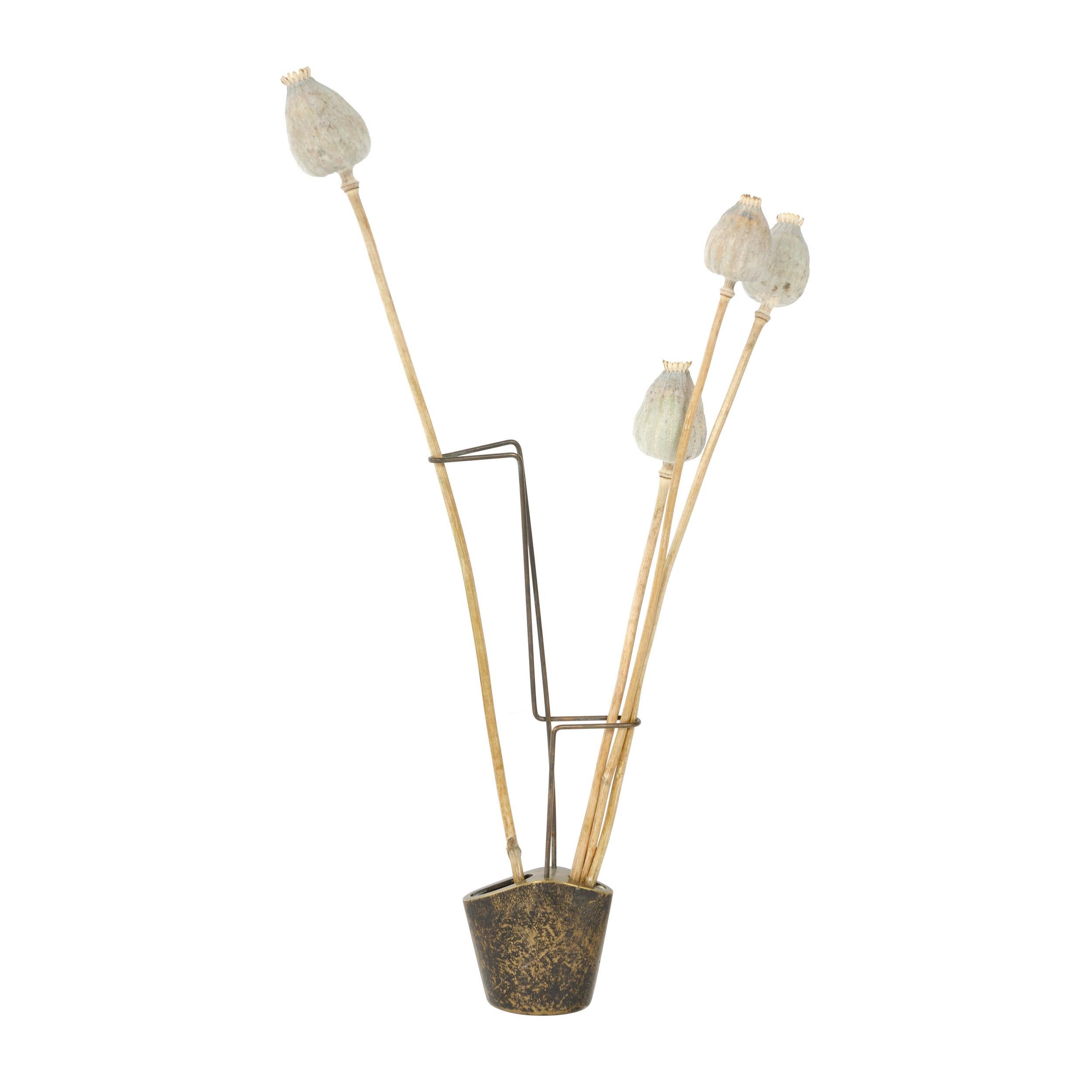 A Mid-Century Modern bud vase by Carl Aubock with an asymmetrical, patinated bronze base supporting a brass wire armature. Made in Austria, circa 1940s.