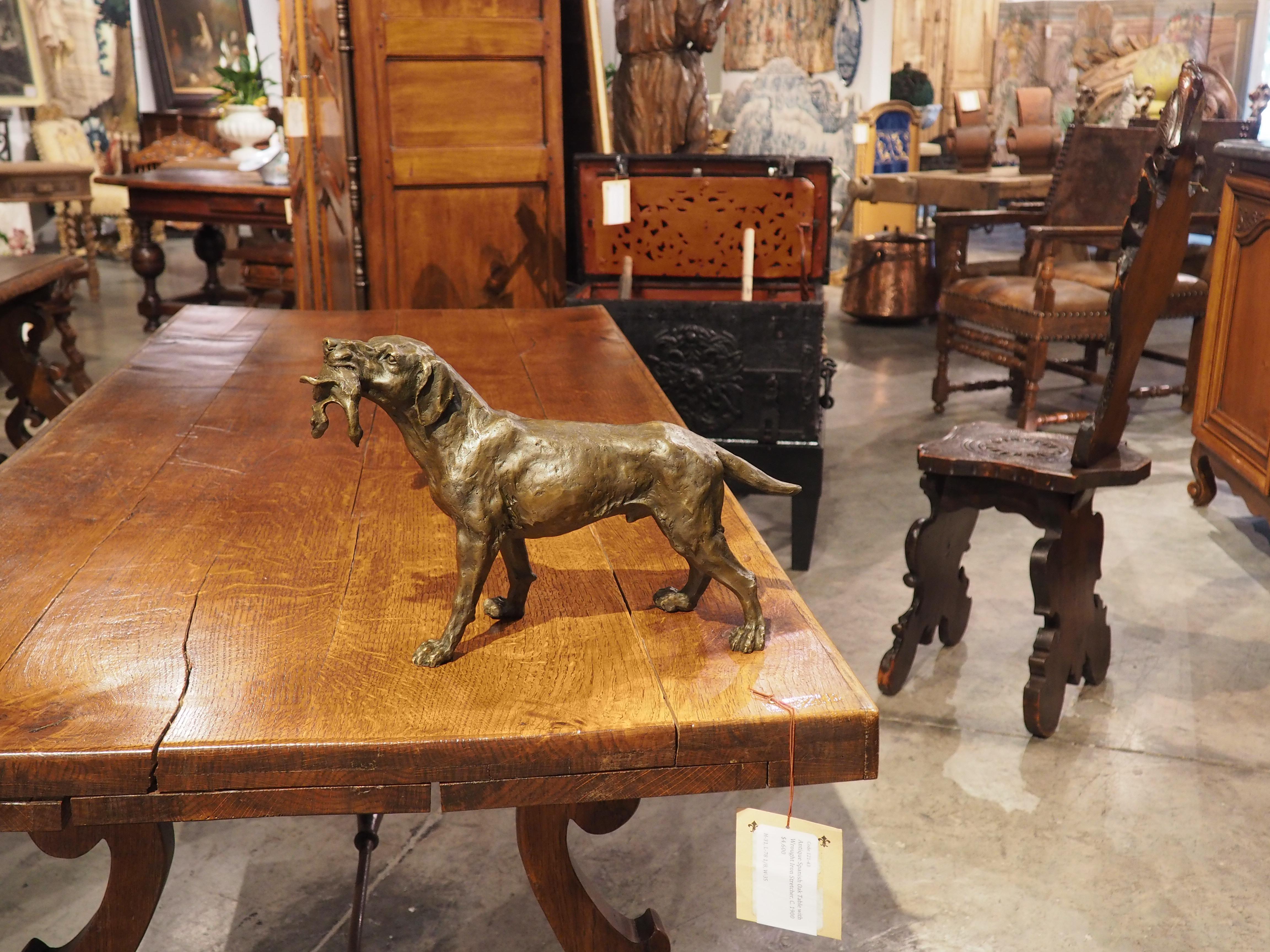 This antique patinated cast bronze sculpture of a hunting dog with bird is after Emile Louis Truffot (1843-1895), who was a pupil of the renowned French sculptor, Francisque Joseph Duret. The stocky retriever stands proudly, with his head held high,