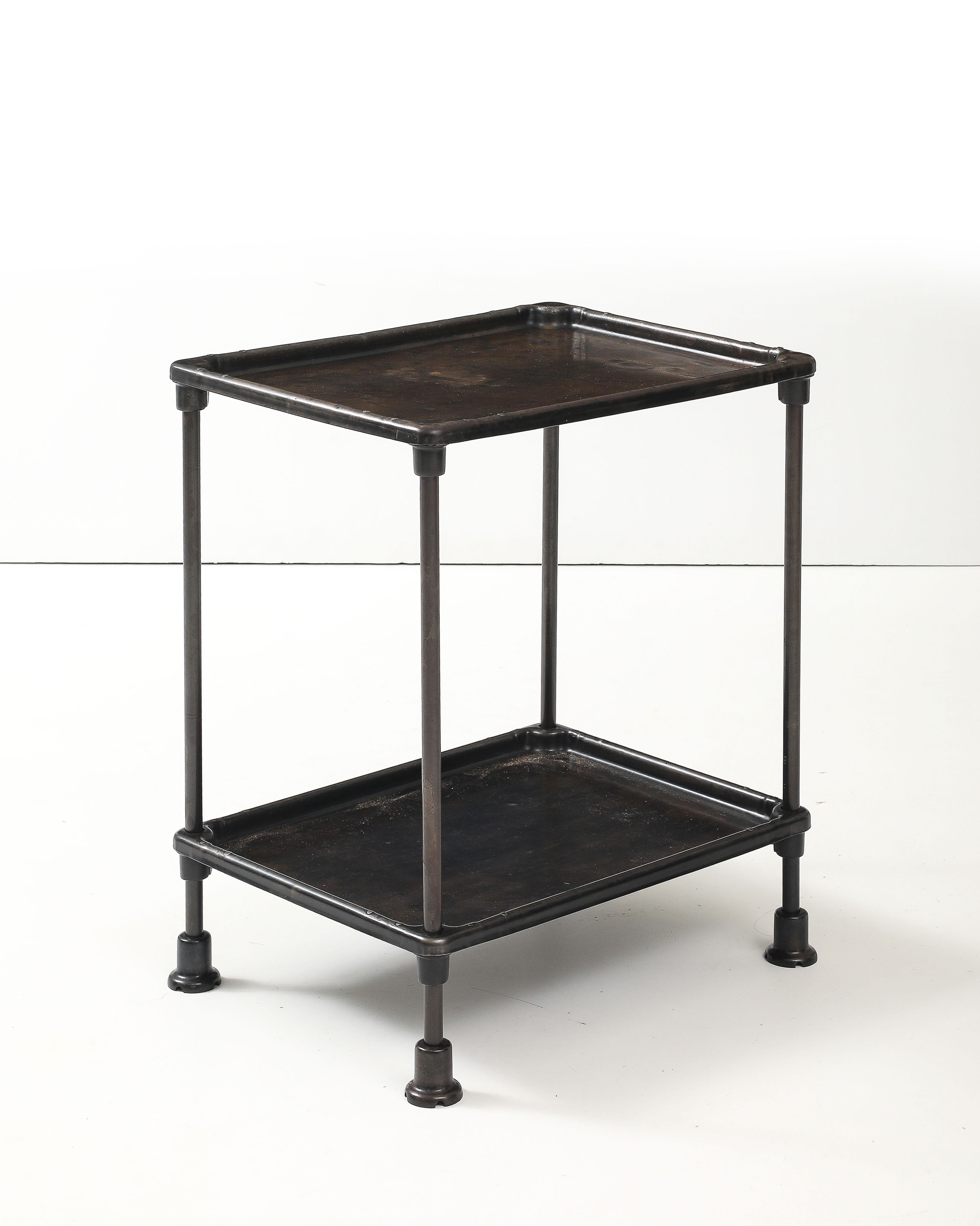 Solid cast iron side table with complex patination and unique texture variations.