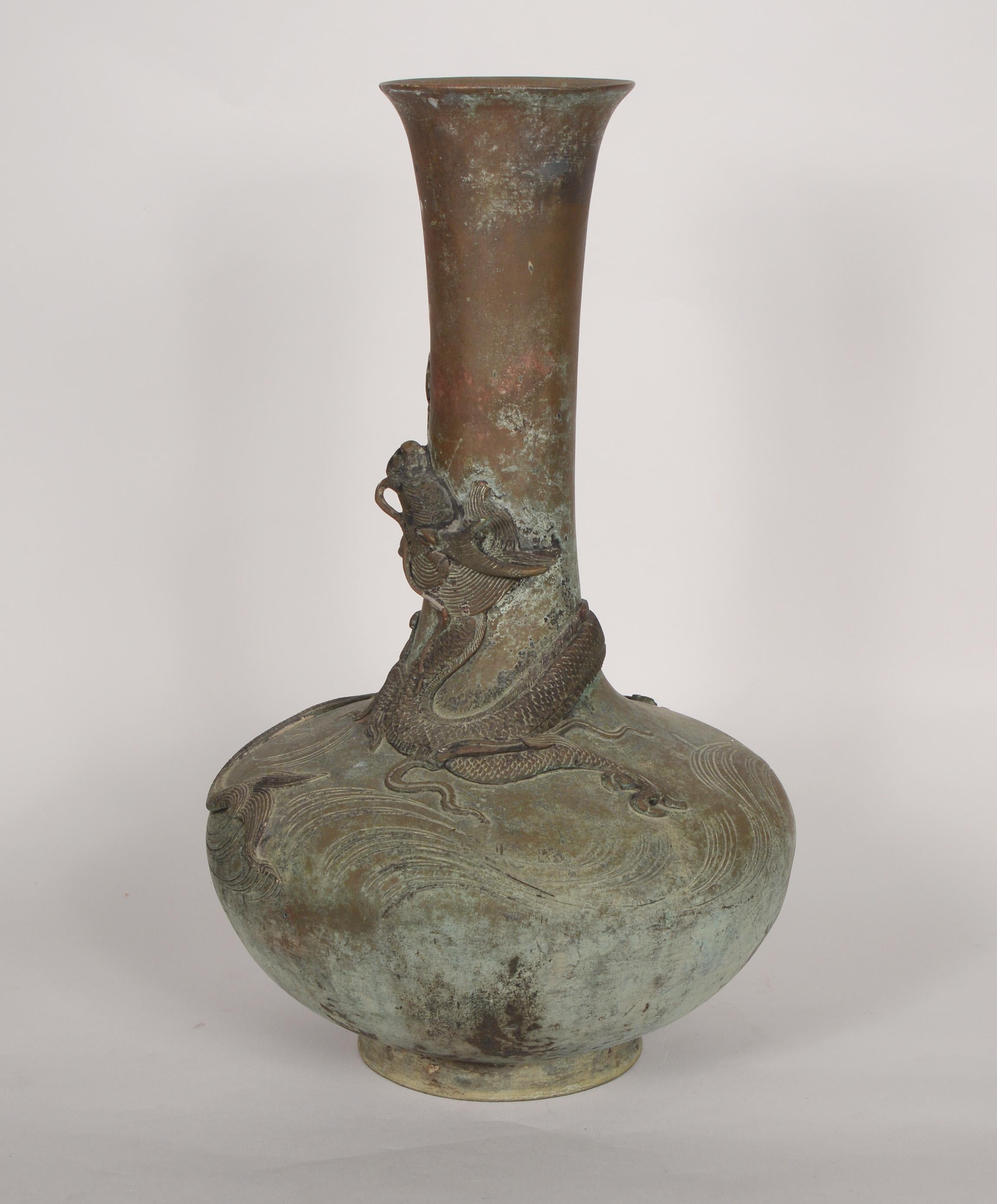Chinese bronze vase with an applied patina. This tall vase has a dragon wrapped around the outside.