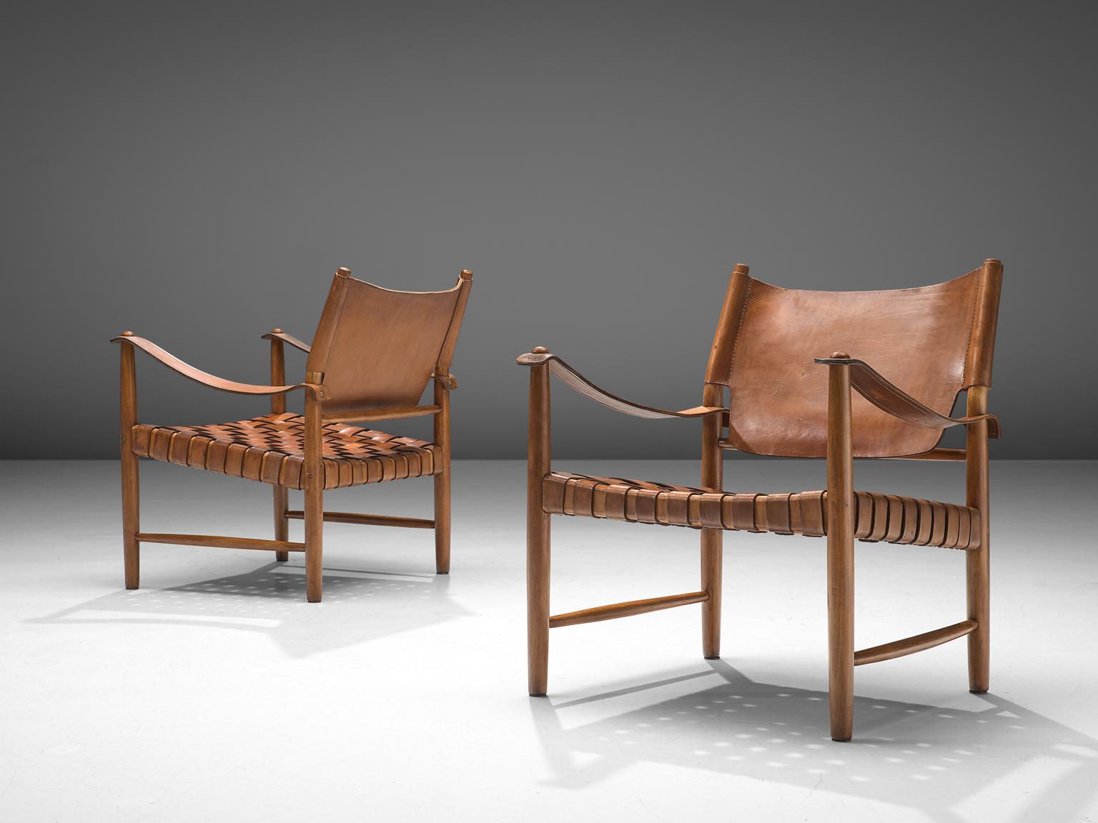 Safari chairs, patinated leather, beech, Denmark, 1950s

These elegant safari chairs features wonderful patinated leather on both the seat and back. The patina on the chairs create a vibrant look and the straps in the seat form a thick,