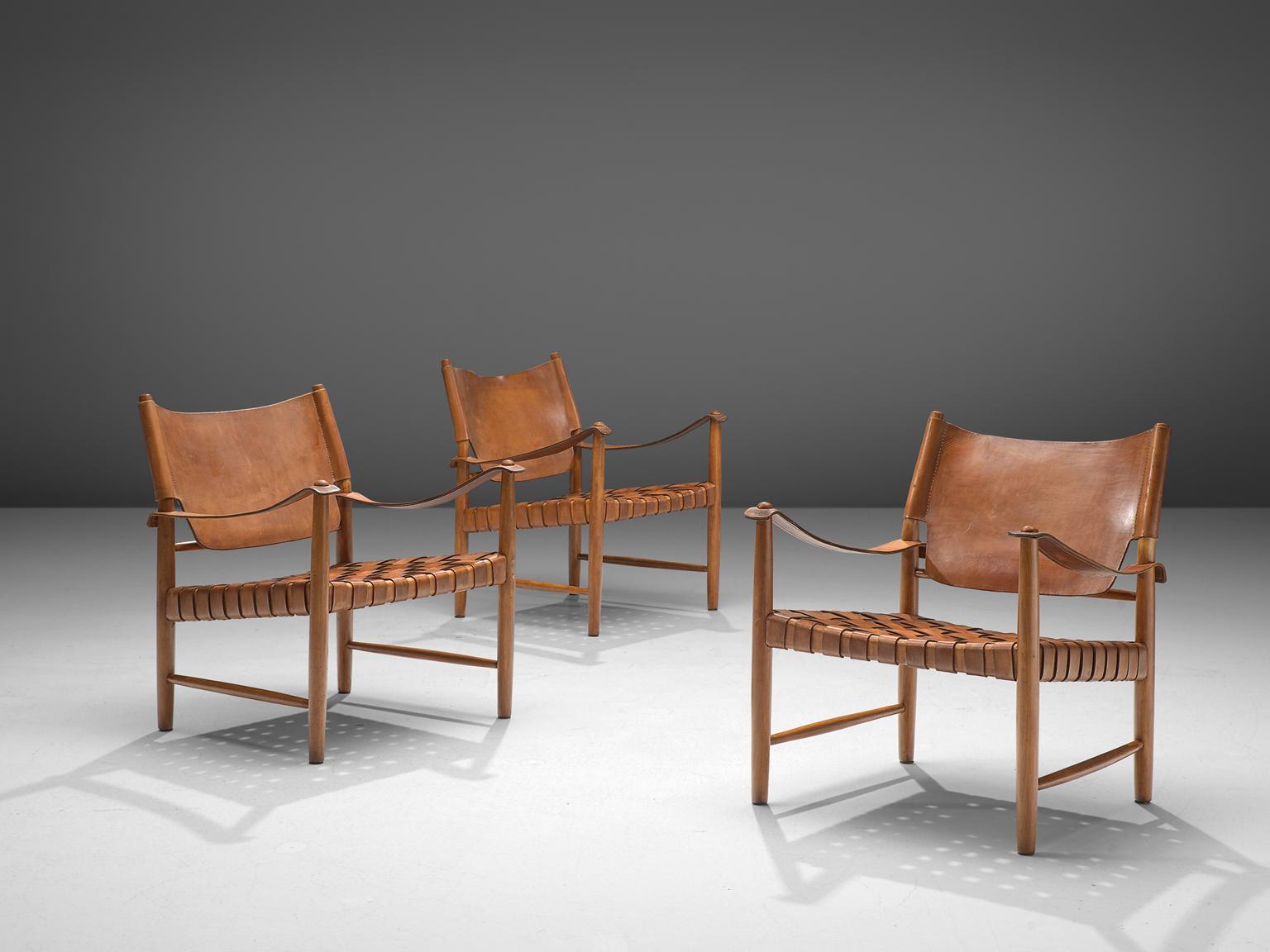 Safari chairs, patinated leather, beeck, Denmark, 1950s.

These elegant safari chairs features wonderful patinated leather on both the seat and back. The seat consists of woven leather straps, while the backrest is made of one leather piece. The