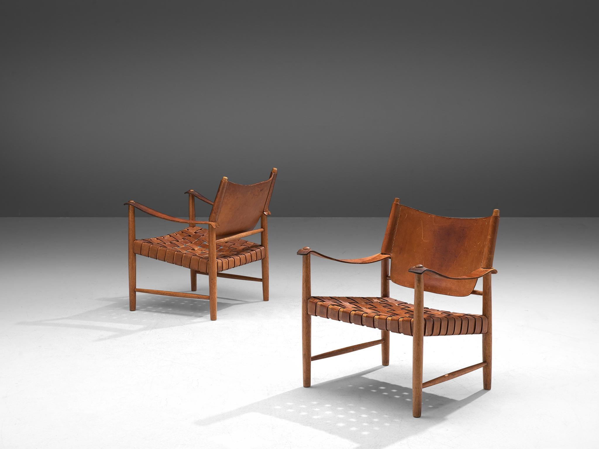 Safari chairs, patinated leather, beech, Denmark, 1950s. 

This elegant set safari chairs features wonderful patinated leather on both the seat, the arms and back. The patina creates a vibrant look which you can only achieve after years and years