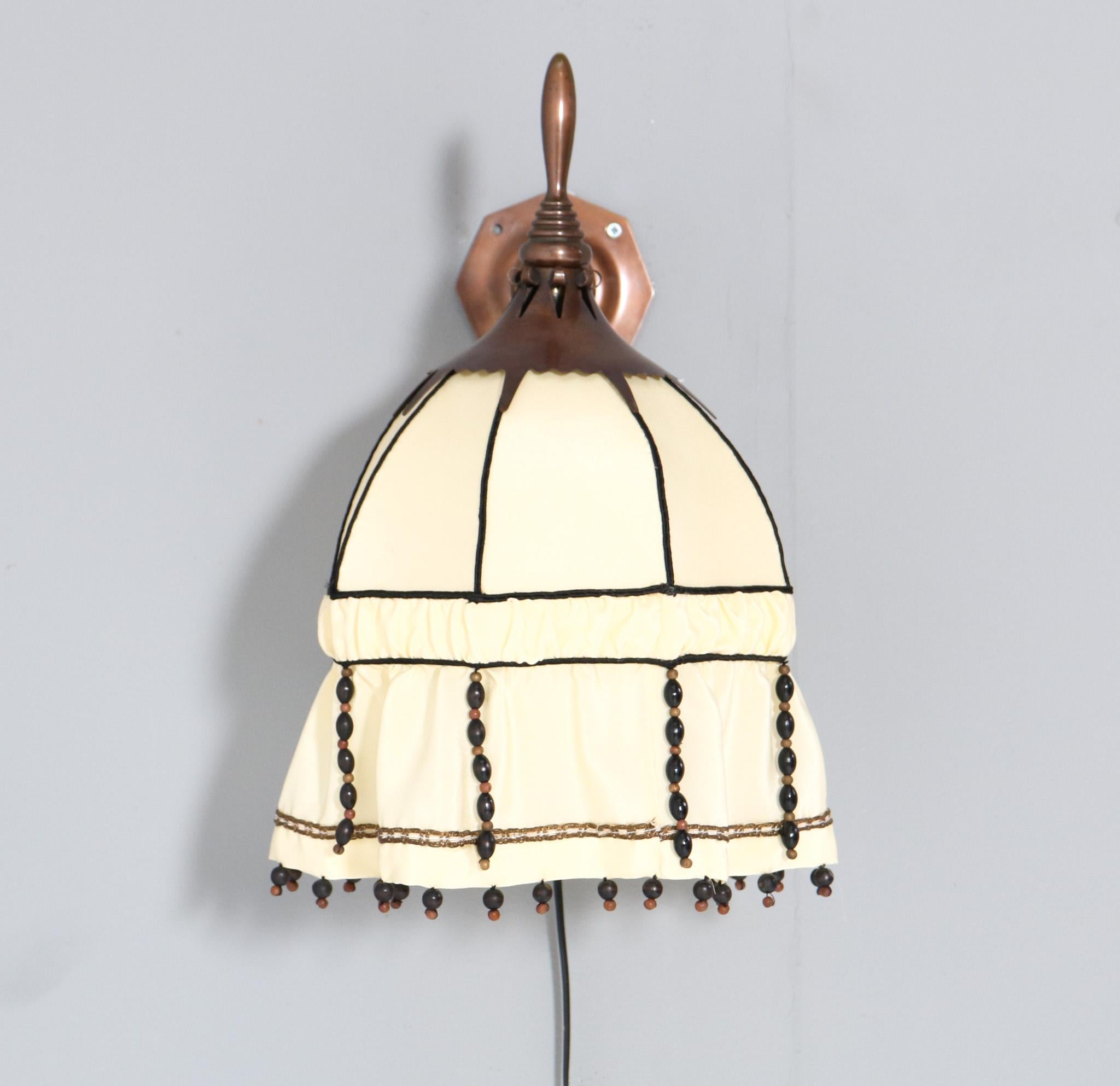 Magnificent and rare Art Deco Amsterdamse School wall light.
Striking Dutch design from the 1920s
Patinated copper frame with renewed shantung silk shade.
In very good original condition with minor wear consistent with age and use, preserving a