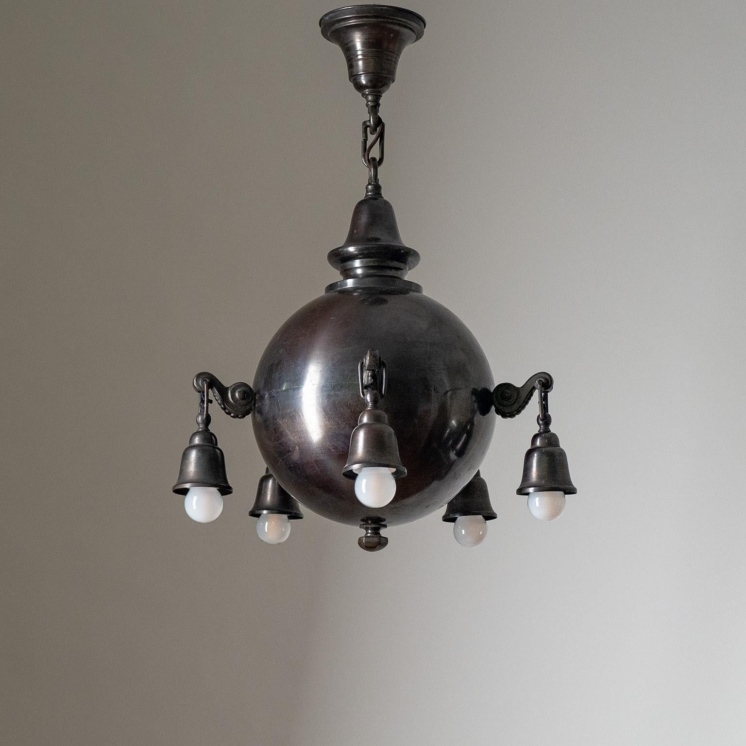 Rare sculptural early 20th century chandelier in dark patinated copper. A large central copper globe (circa 30cm/12″) with five sculpted arms, each with an original brass and ceramic E27 socket and new wiring.
Measures: Height 69cm (27″), Diameter