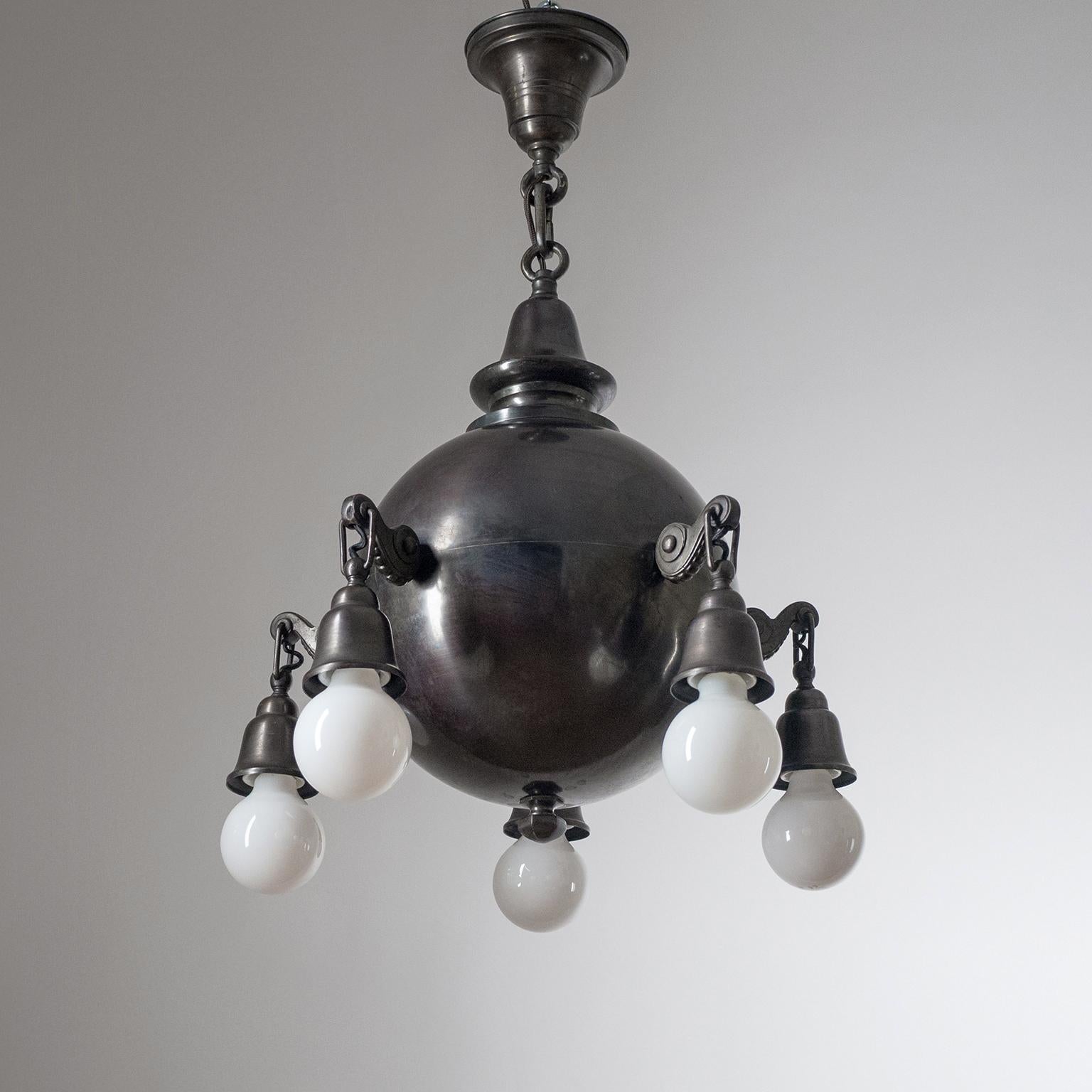 Rare sculptural early 20th century chandelier in dark patinated copper. A large central copper globe (circa 12inches/30cm) with five sculpted arms, each with an original brass and ceramic E27 socket and new wiring.
