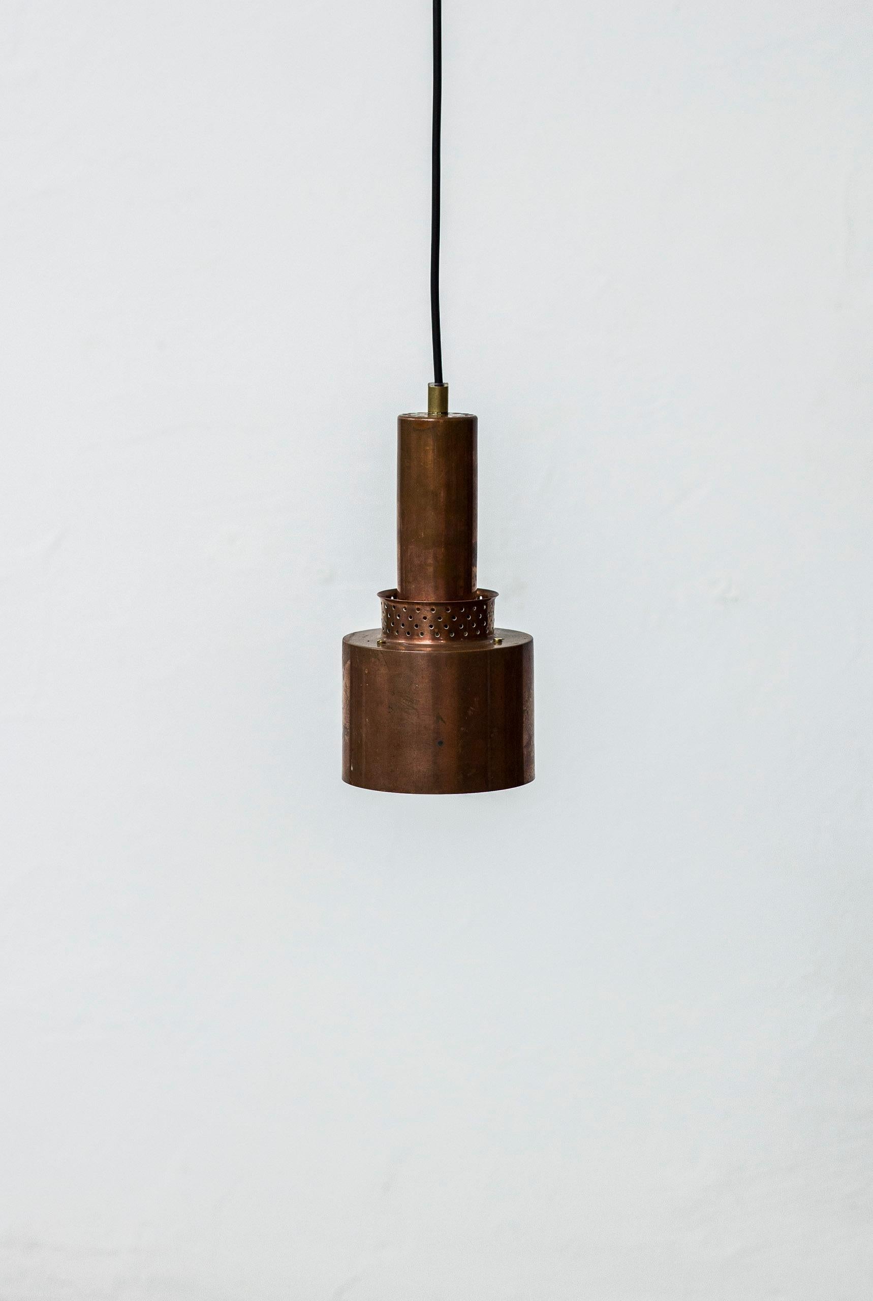 Pendant lamps designed by Hans Agne Jakobsson. produced by his own company in Sweden during the 1950s. Made from solid copper with original patina. Brass screws and details. All three with original ceiling mount in copper. New electric components.