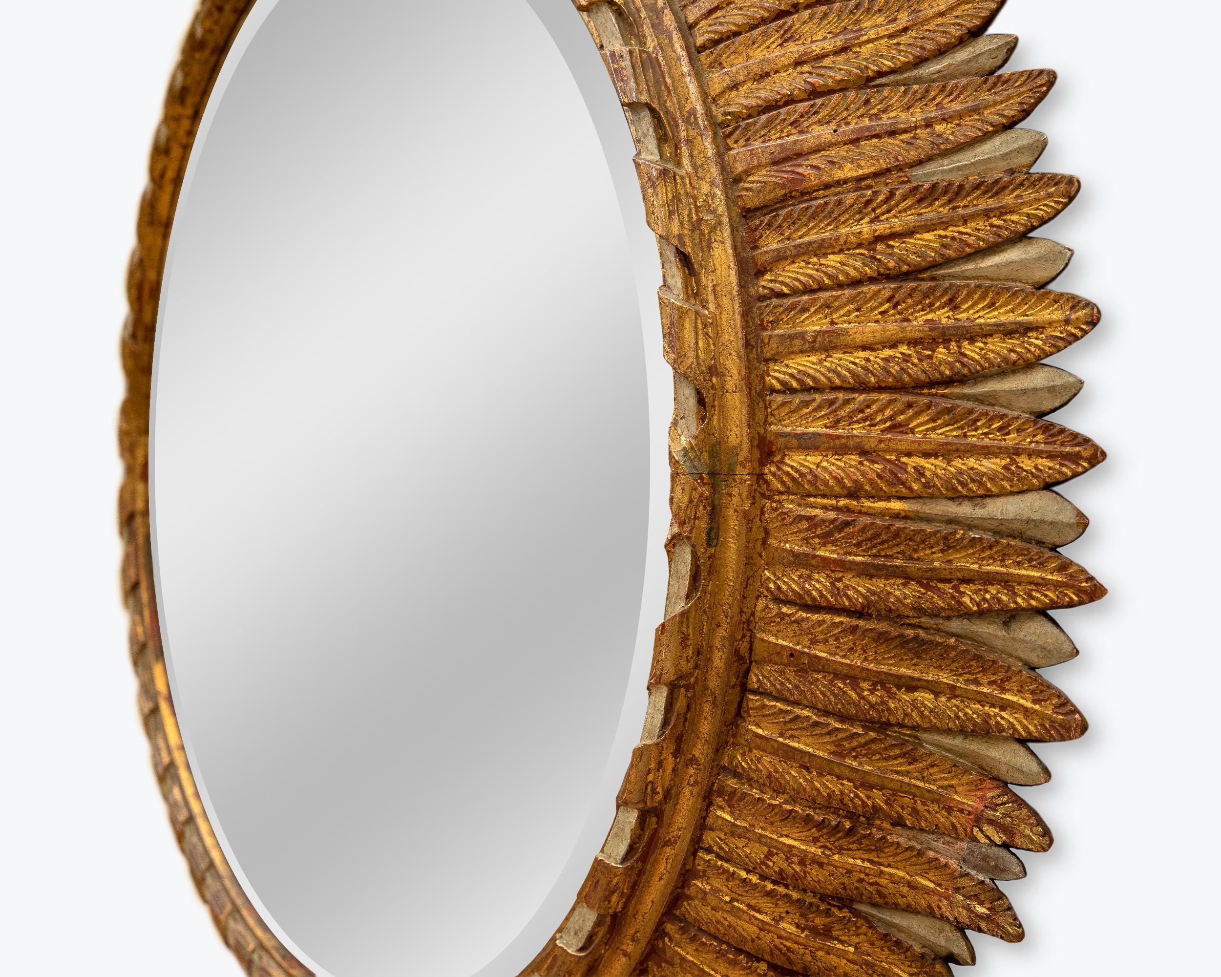Patinated carved wood and gold leaf mirror, attributed to Maison Jansen, France, circa 1950.